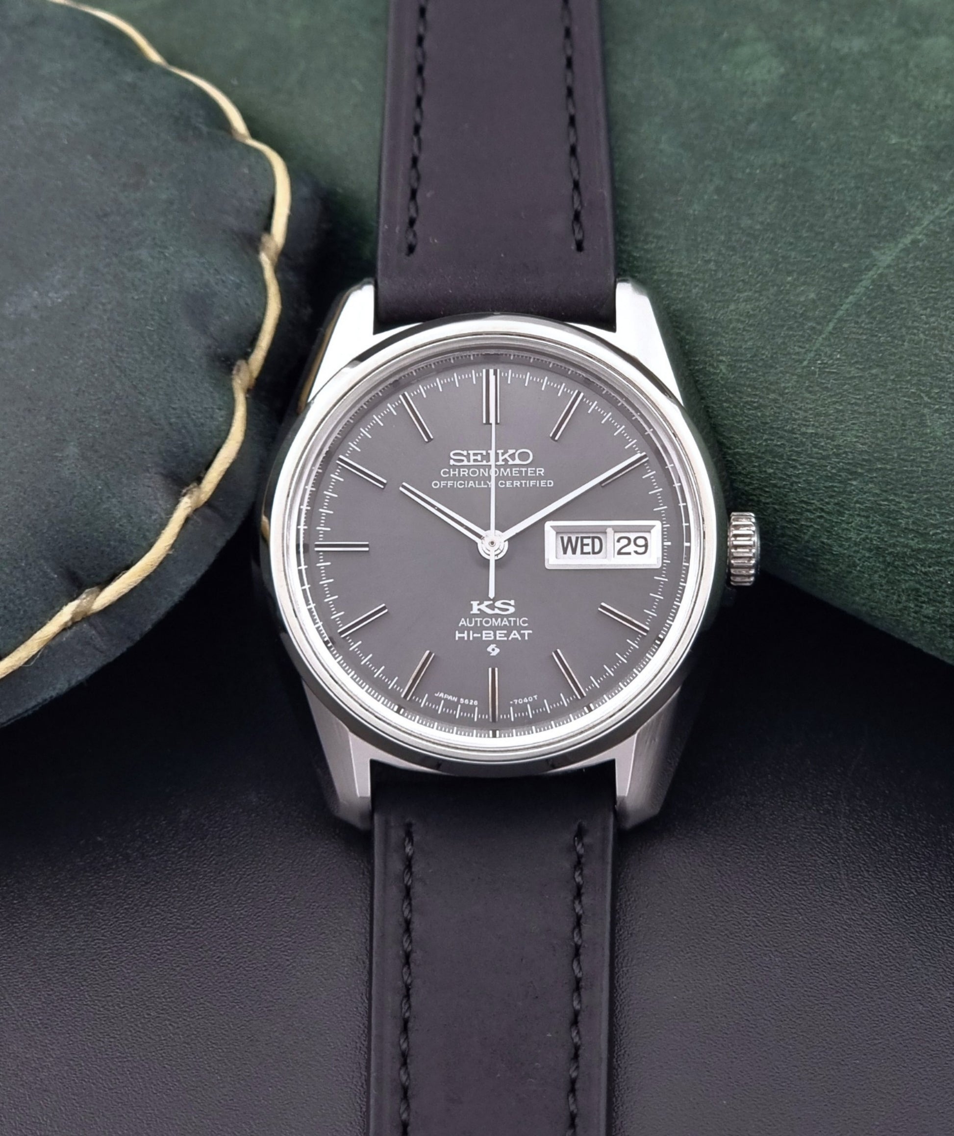 King Seiko watch 5626-7040 watch with black leather strap on a green and gray background front