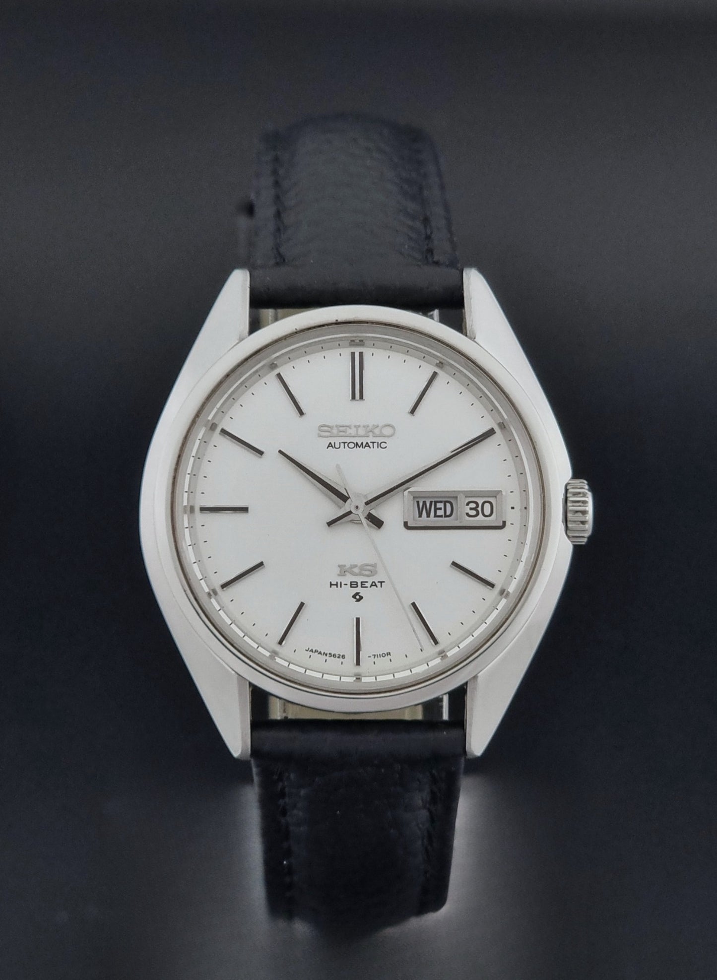 Vintage King Seiko 5626-7111 Wristwatch with a black strap on a dark background close dial view