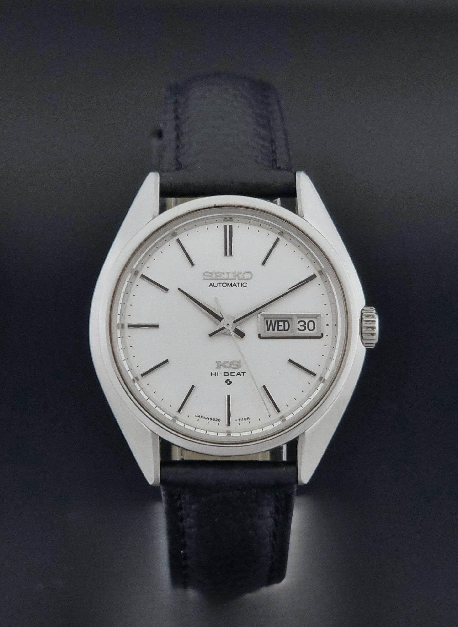 Vintage King Seiko 5626-7111 Wristwatch with a black strap on a dark background close dial view