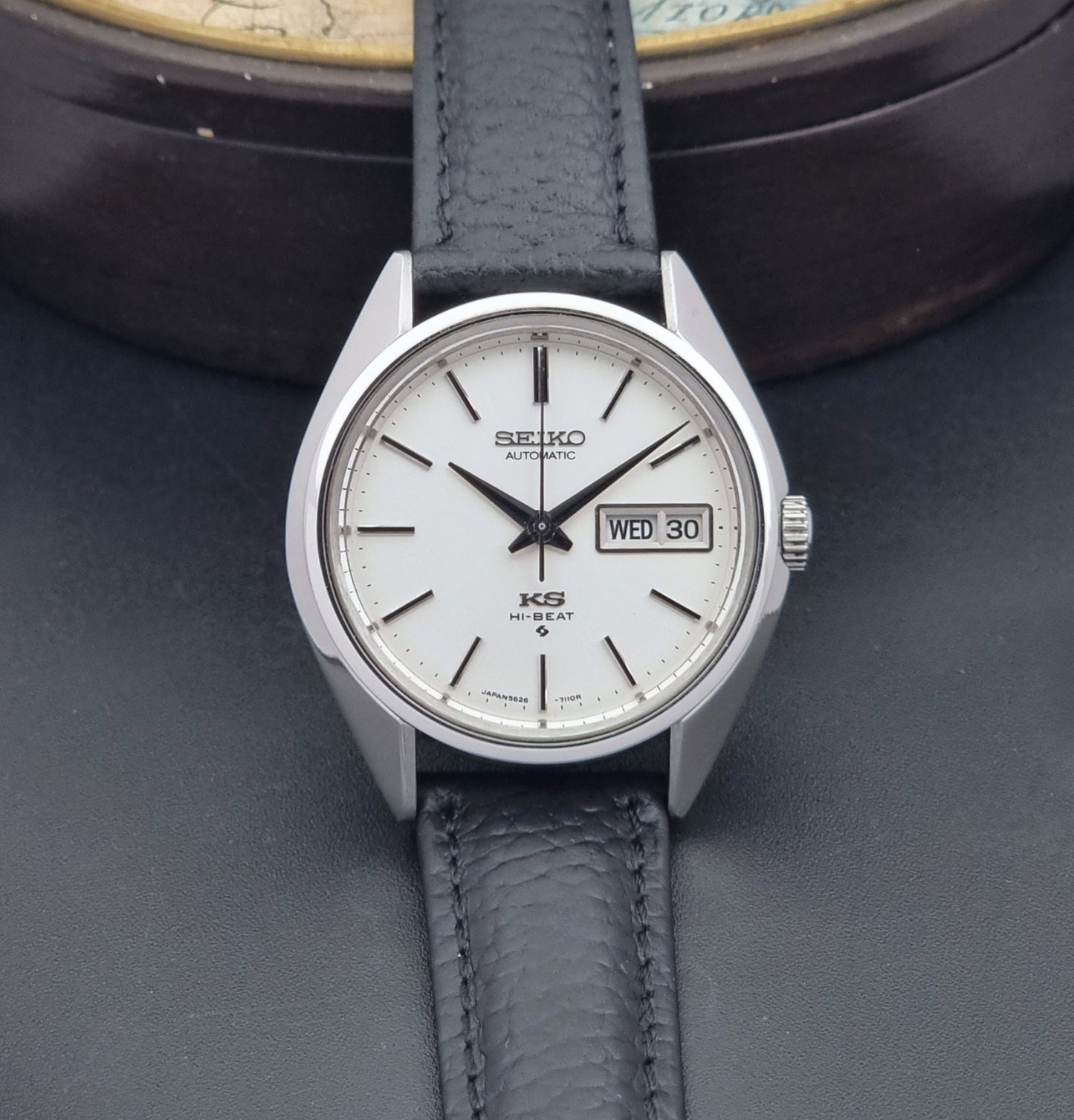 Vintage King Seiko 5626-7111 Wristwatch with a black strap on a dark background dial view