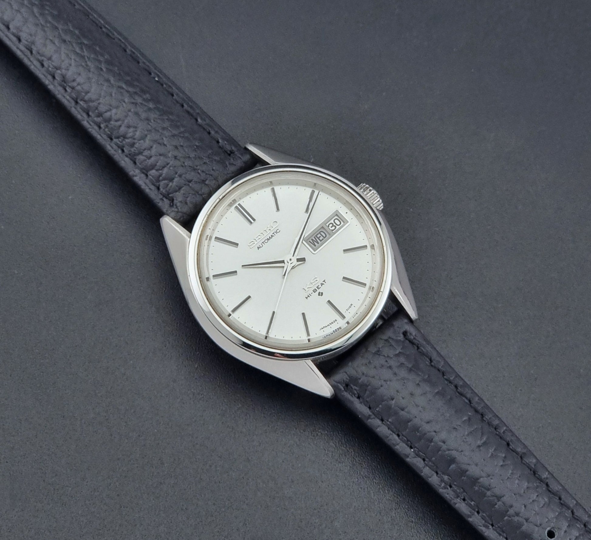 Vintage King Seiko 5626-7111 Wristwatch with a black strap on a dark background dial