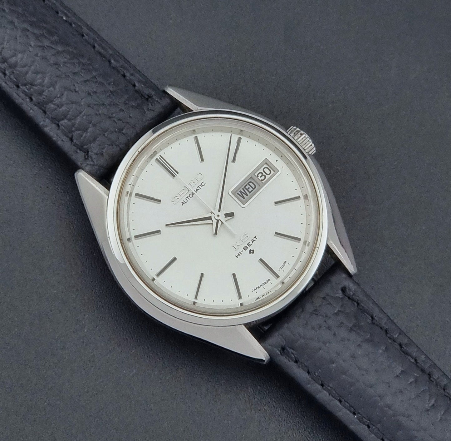 Vintage King Seiko 5626-7111 Wristwatch with a black strap on a dark background close up dial view