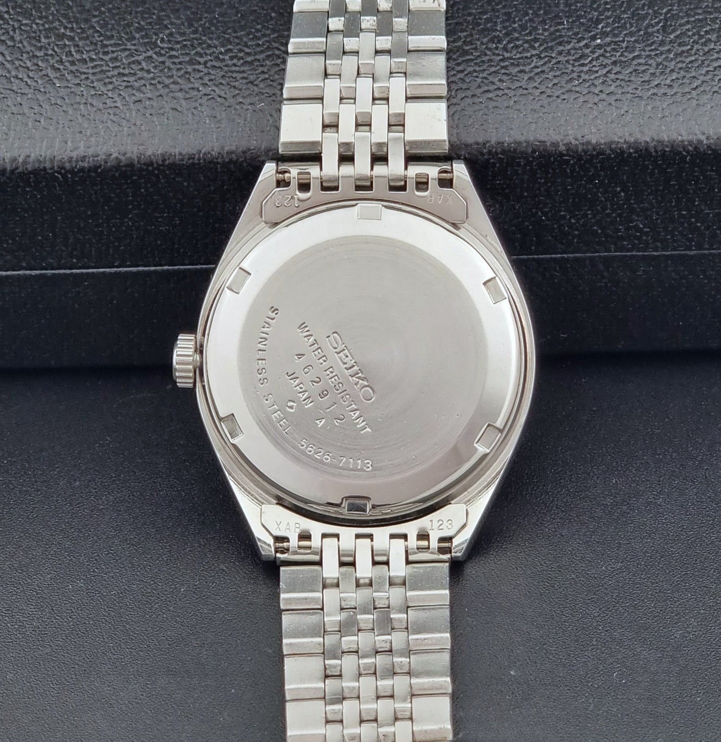 Vintage King Seiko Wristwatch 5626-7113 with a white face on a dark background case back view