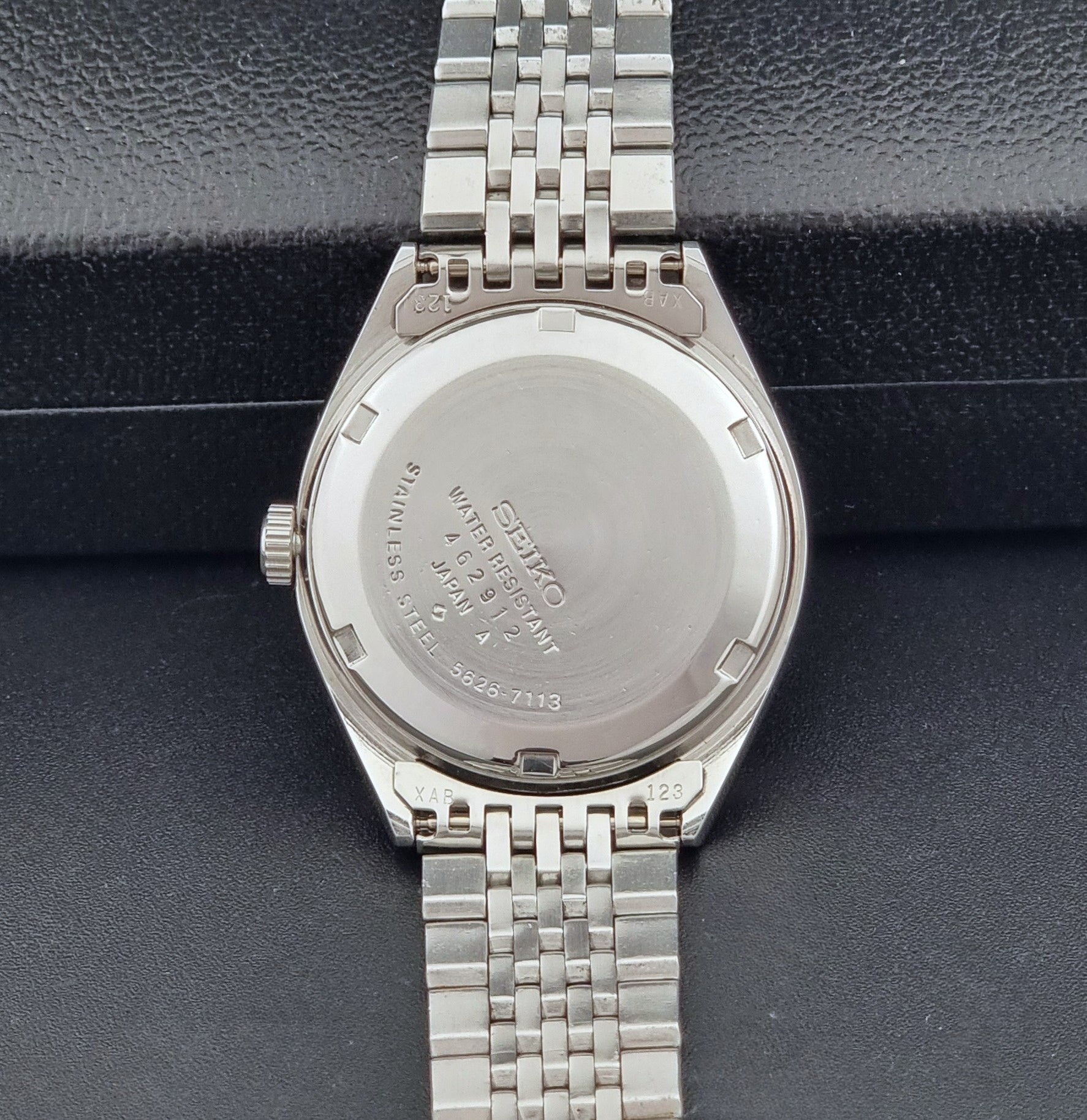 Vintage King Seiko Wristwatch 5626-7113 with a white face on a dark background case back view