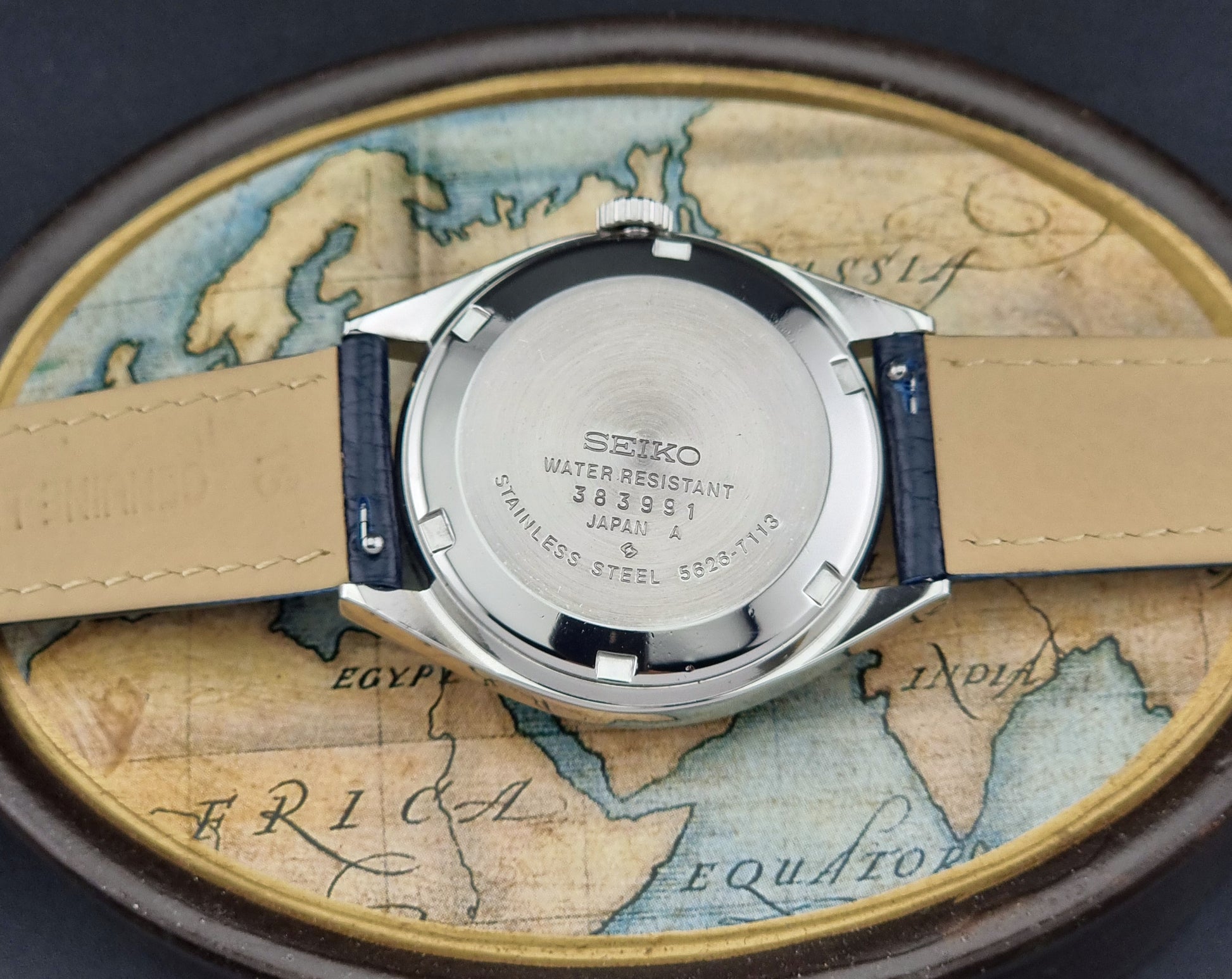 Vintage King Seiko 5626-71113 Wristwatch case back on a world map background