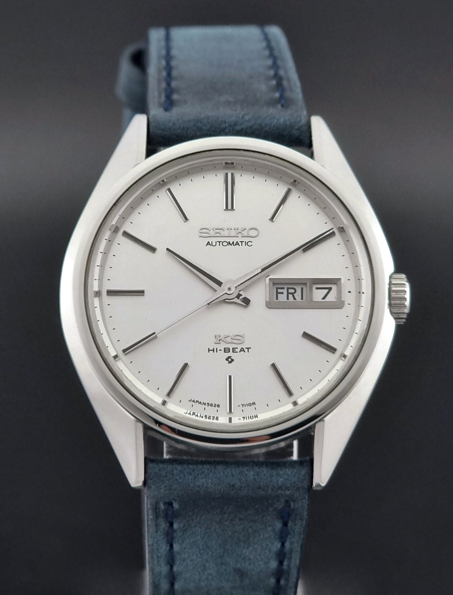 Vintage King Seiko wristwatch with a blue strap on a dark background close up dial