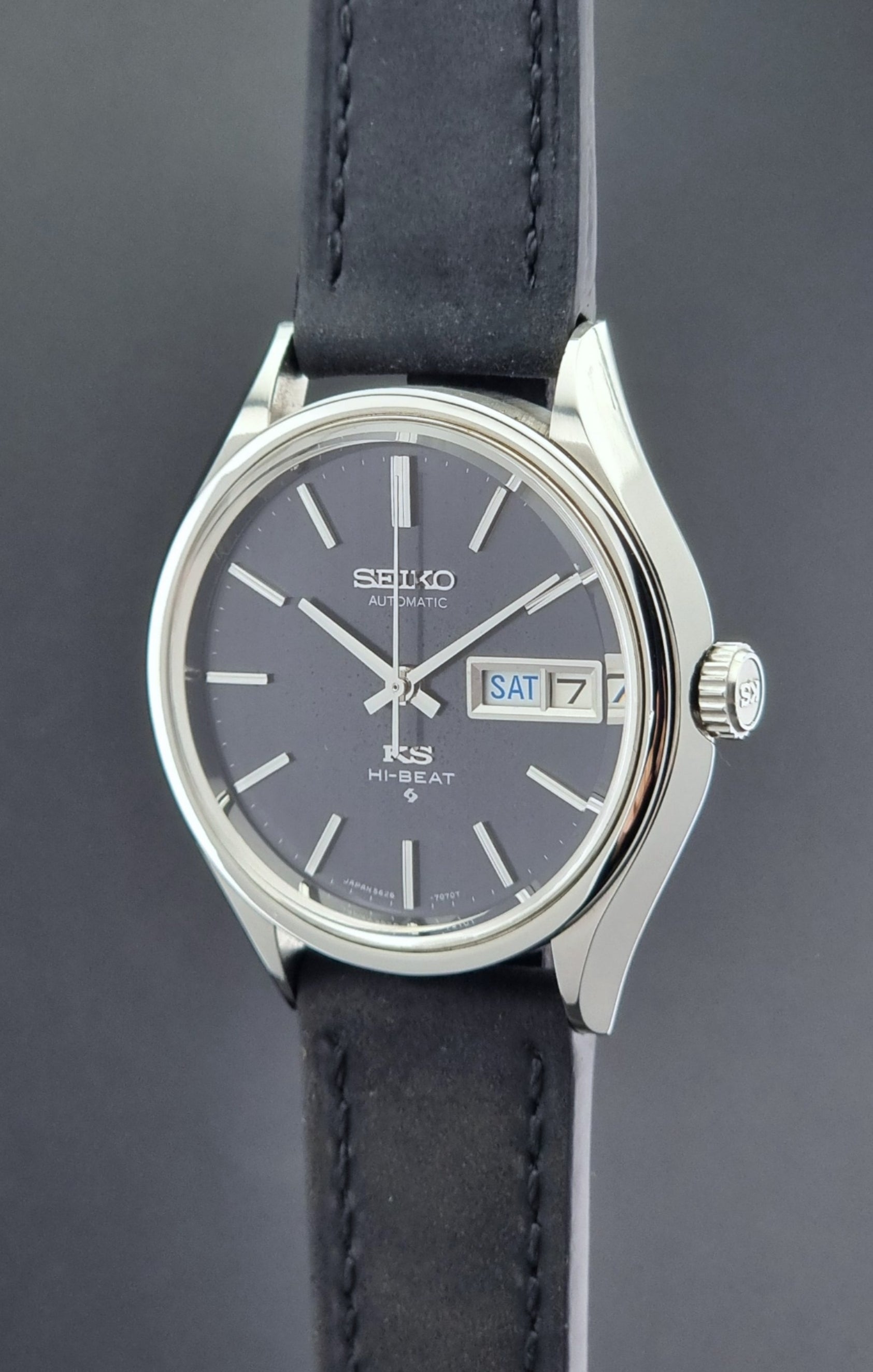 Vintage King Seiko Wristwatch 5626-7120 with black leather strap on a dark surface crown profile view