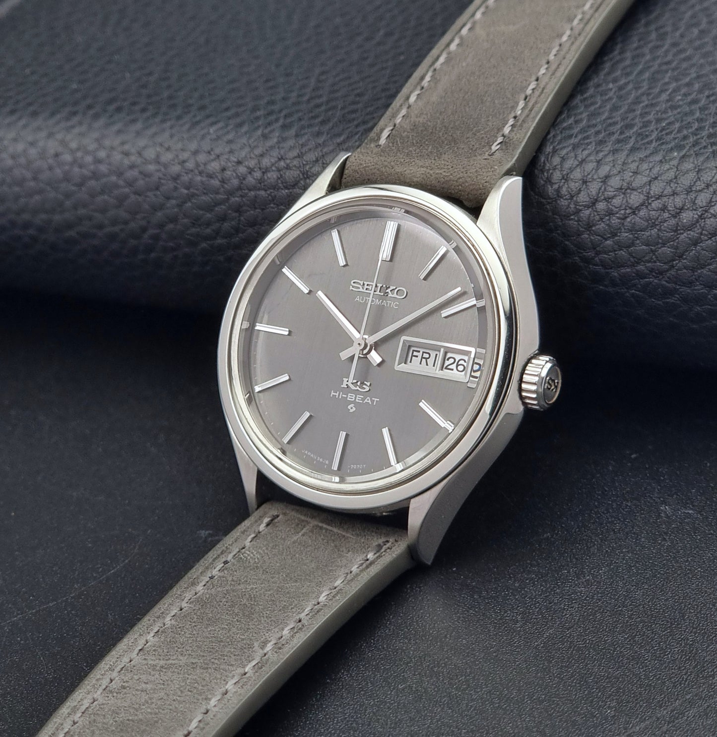 Vintage King Seiko watch with gray strap on a dark textured background