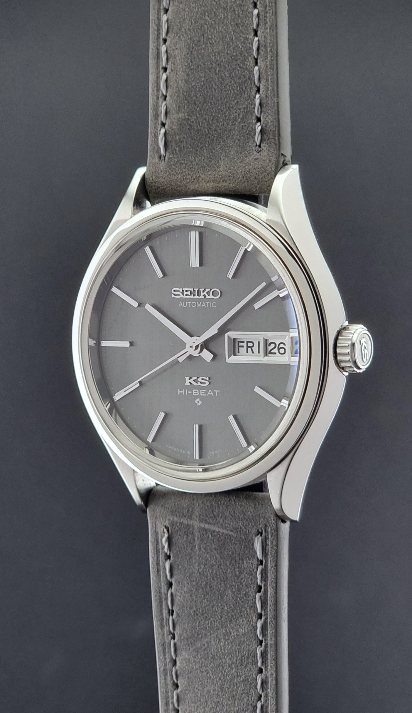 Vintage King Seiko watch with gray leather strap on a dark background