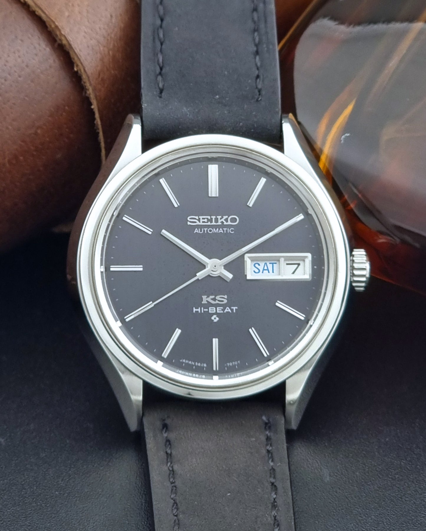 Vintage King Seiko Wristwatch 5626-7120 with black leather strap on a dark surface close up dial view