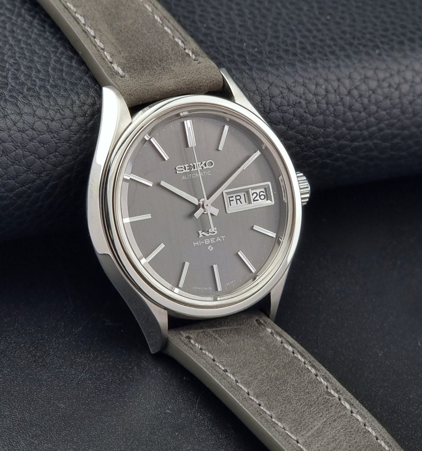 Vintage King Seiko watch with gray strap on a dark textured background