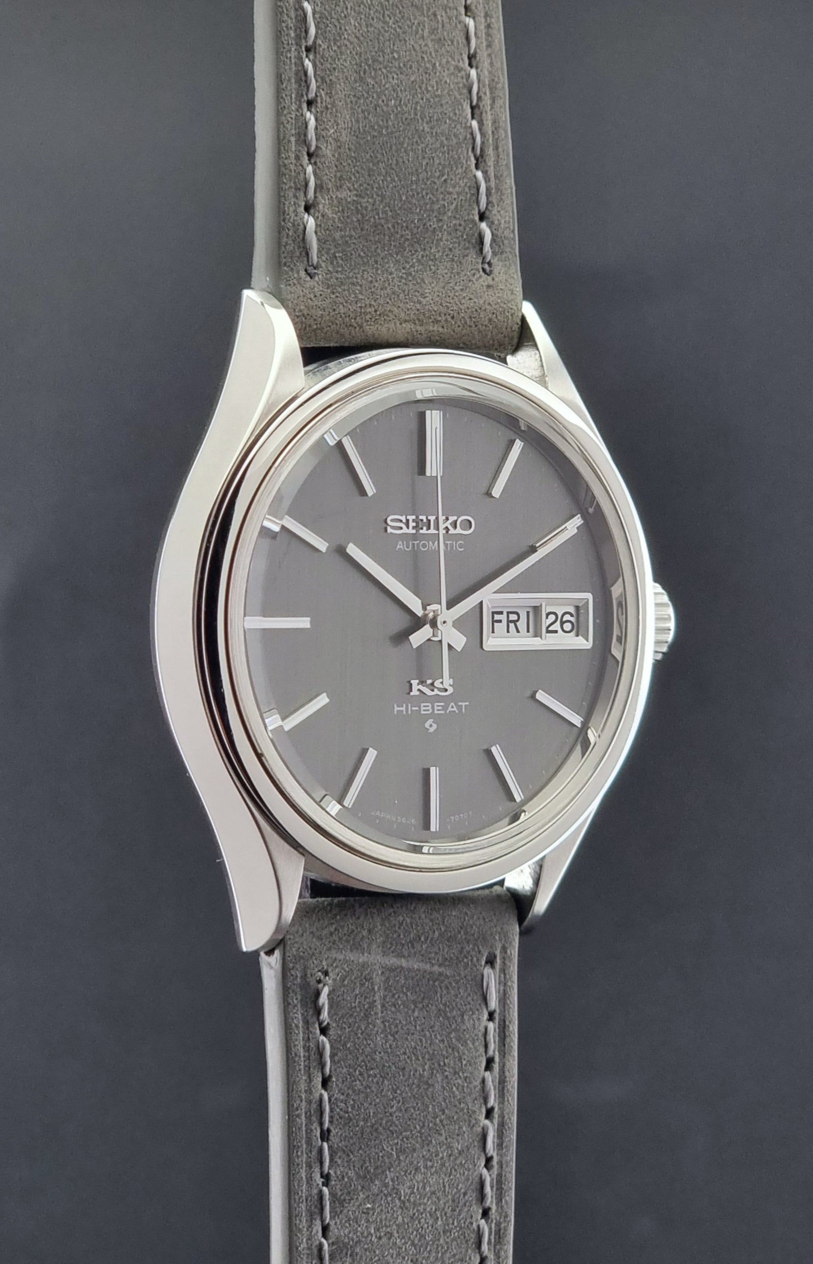 Vintage King Seiko watch with gray strap and gray dial on a dark background