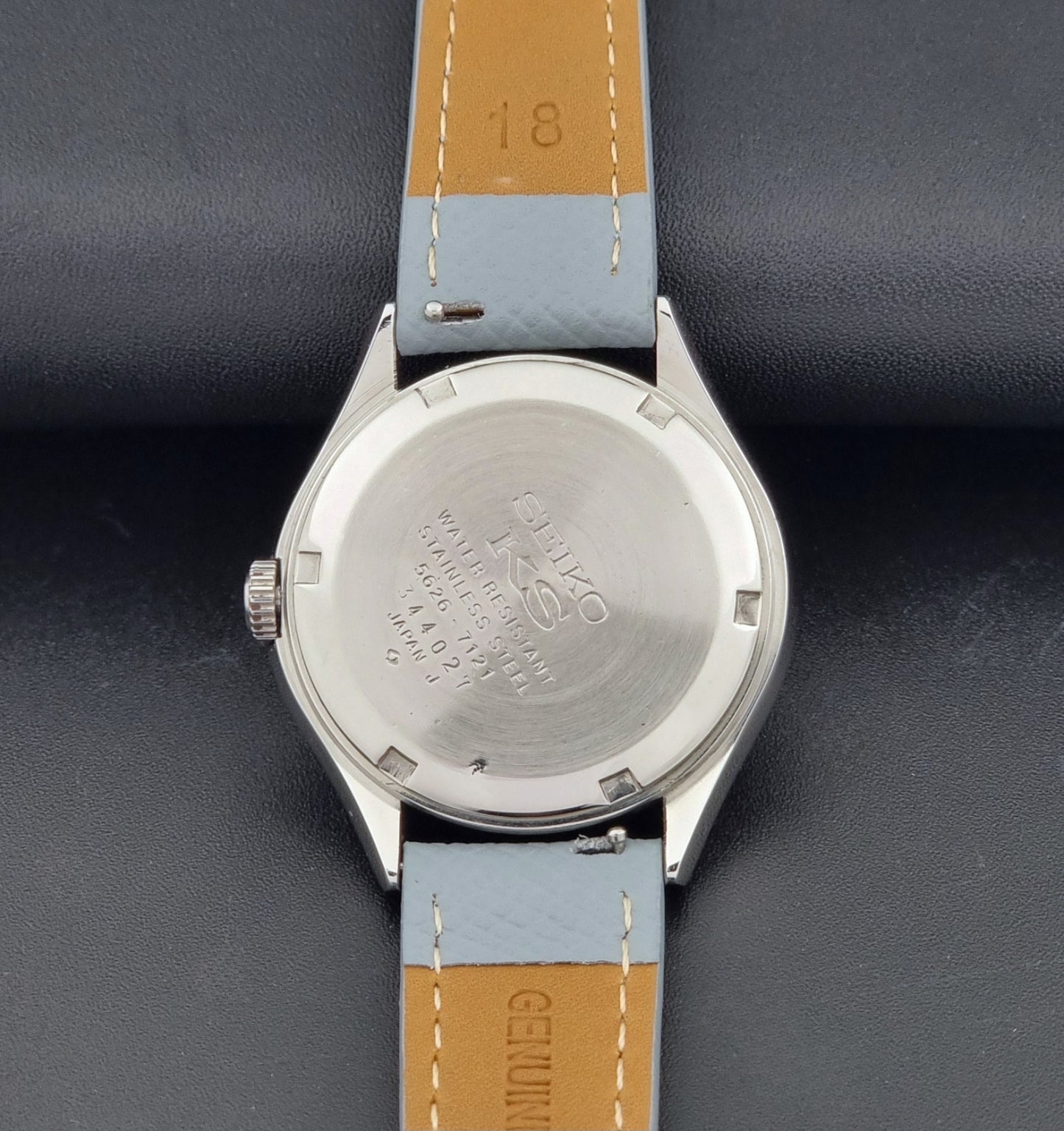Vintage King Seiko Wristwatch 5626-7121 with a grey strap on a dark background case back view