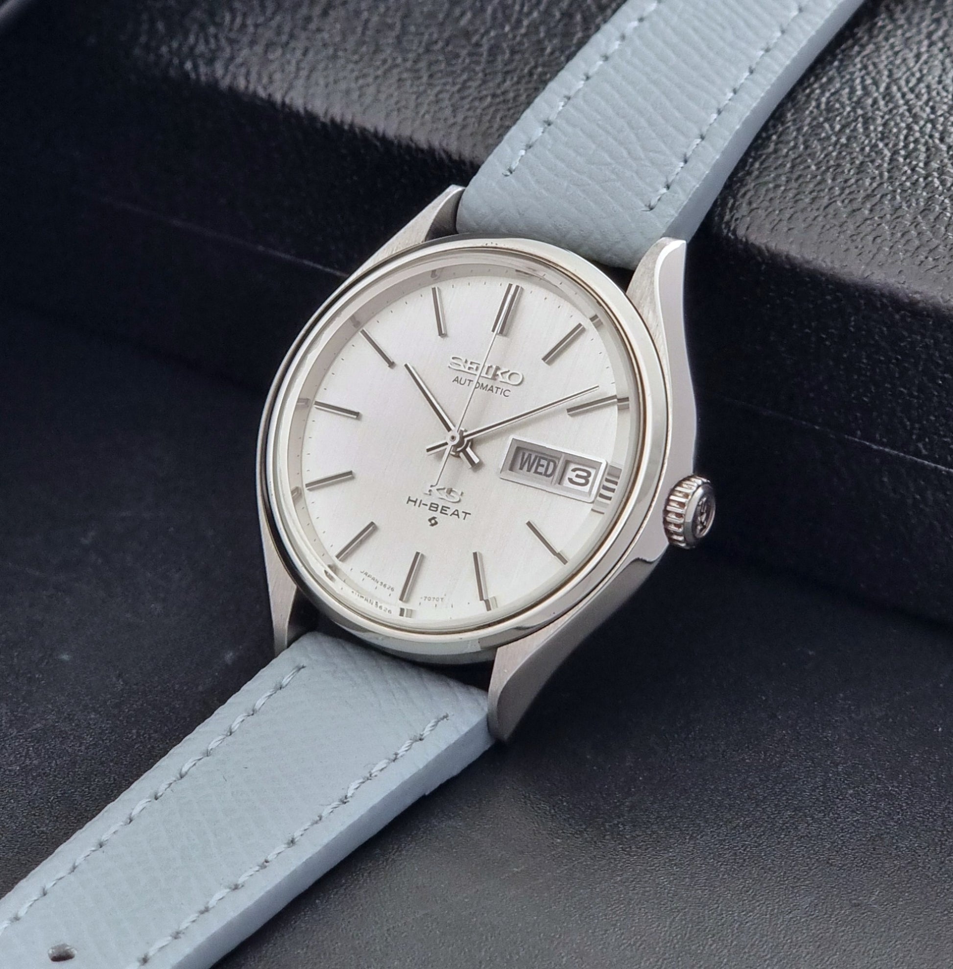 Vintage King Seiko Wristwatch 5626-7121 with a grey strap on a dark background crown view