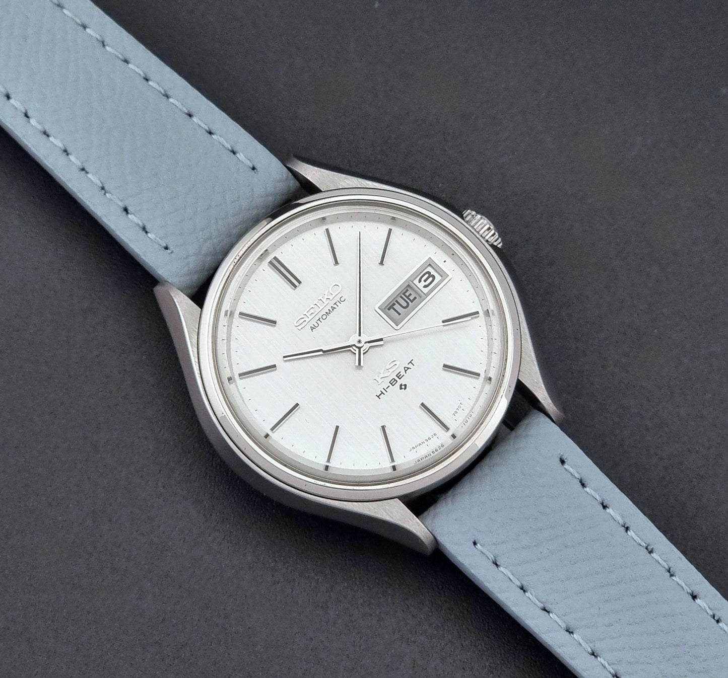 Vintage King Seiko Wristwatch 5626-7121 with a grey strap on a dark background close up dial view