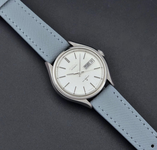 Vintage King Seiko Wristwatch 5626-7121 with a grey strap on a dark background dial