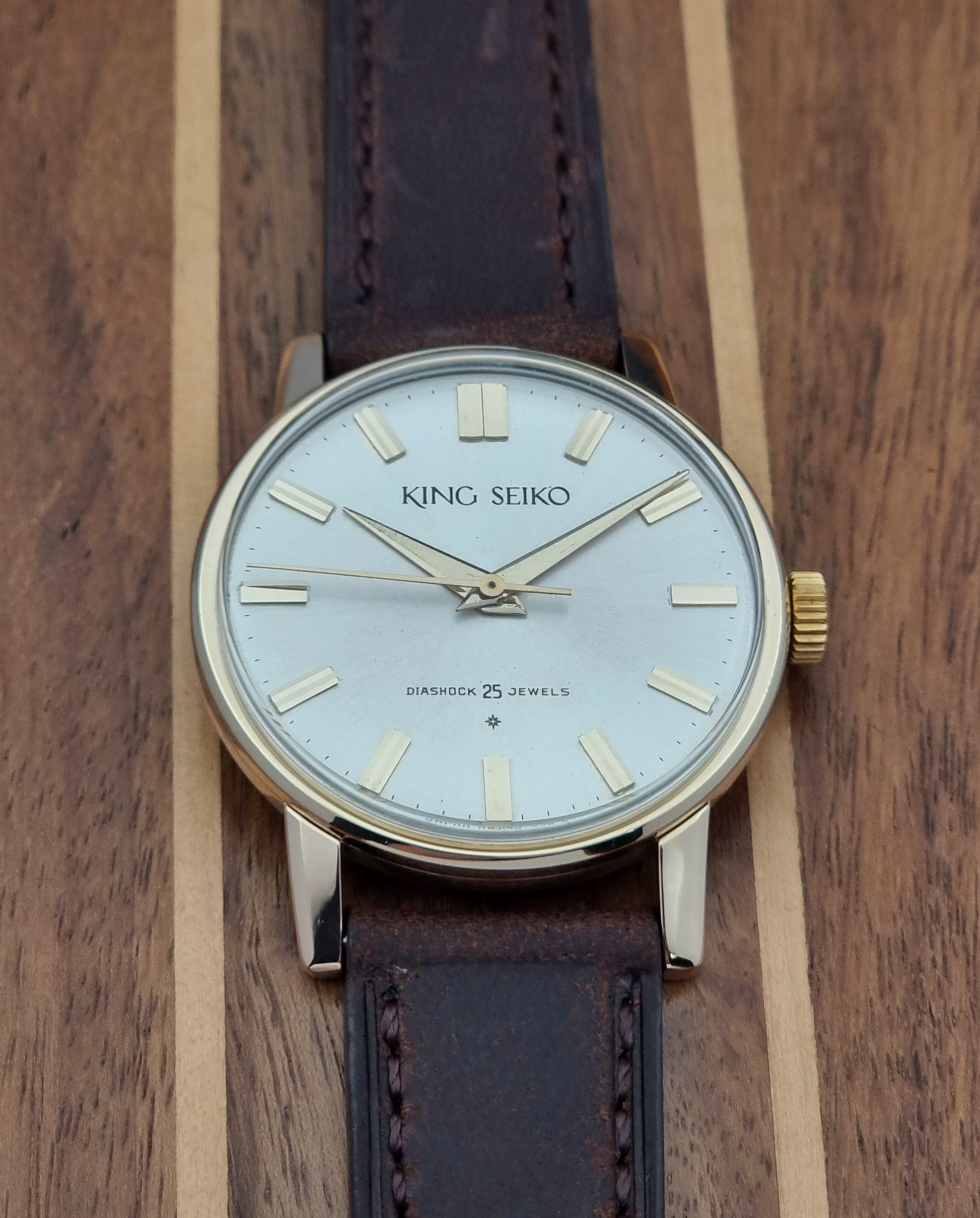Vintage King Seiko Watch J14102 with brown leather strap on a wooden surface front