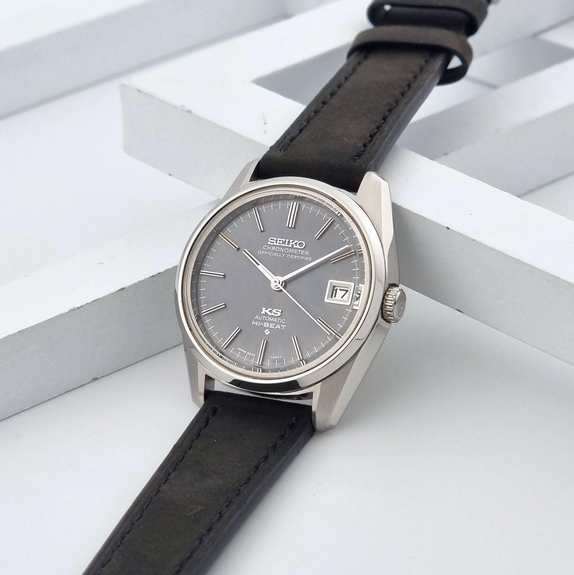 Vintage King Seiko 5625-7040 watch watch with black leather strap on a light gray background crown view