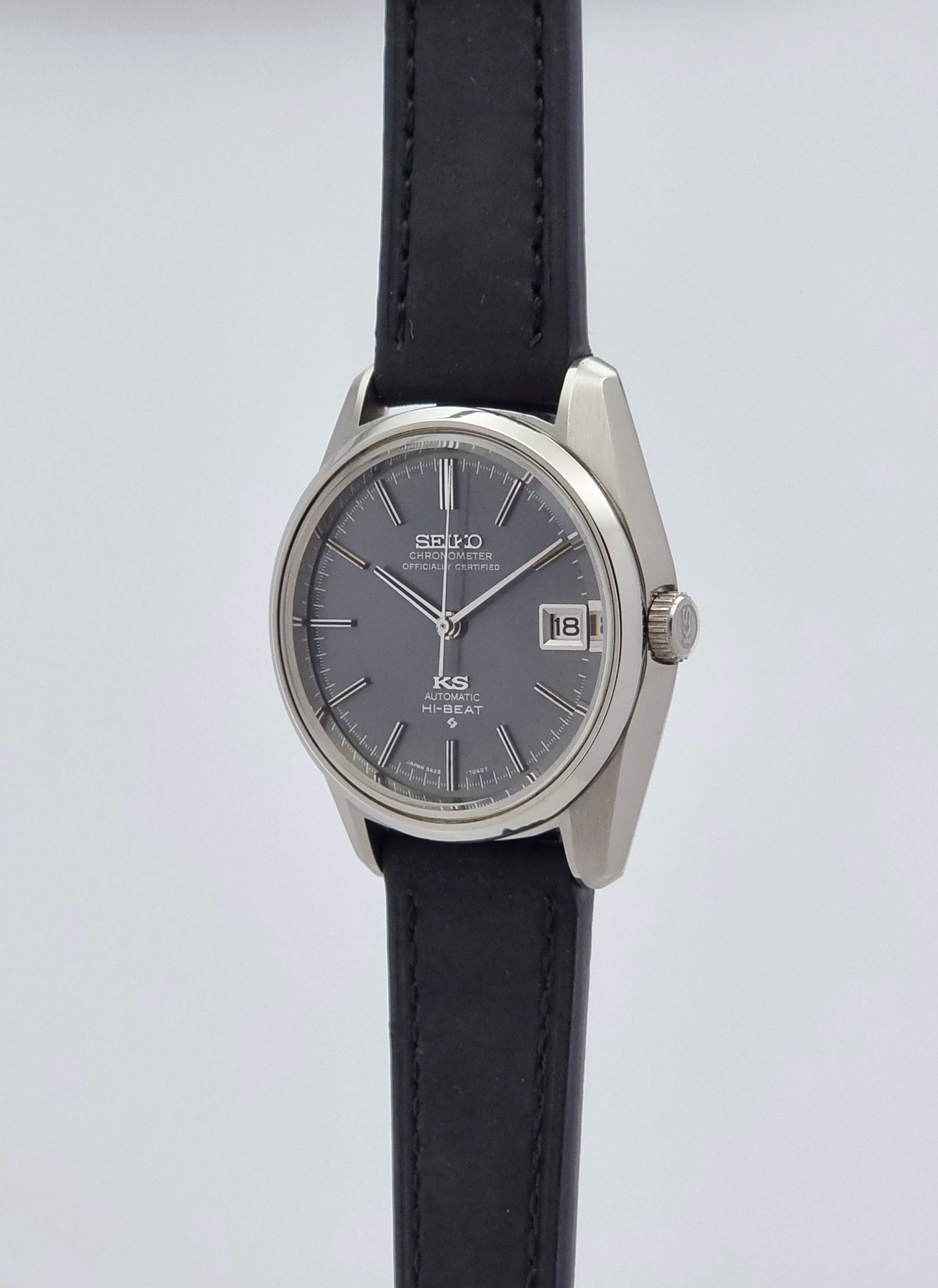 Vintage King Seiko 5625-7040 watch watch with black leather strap on a light gray background crown profile view