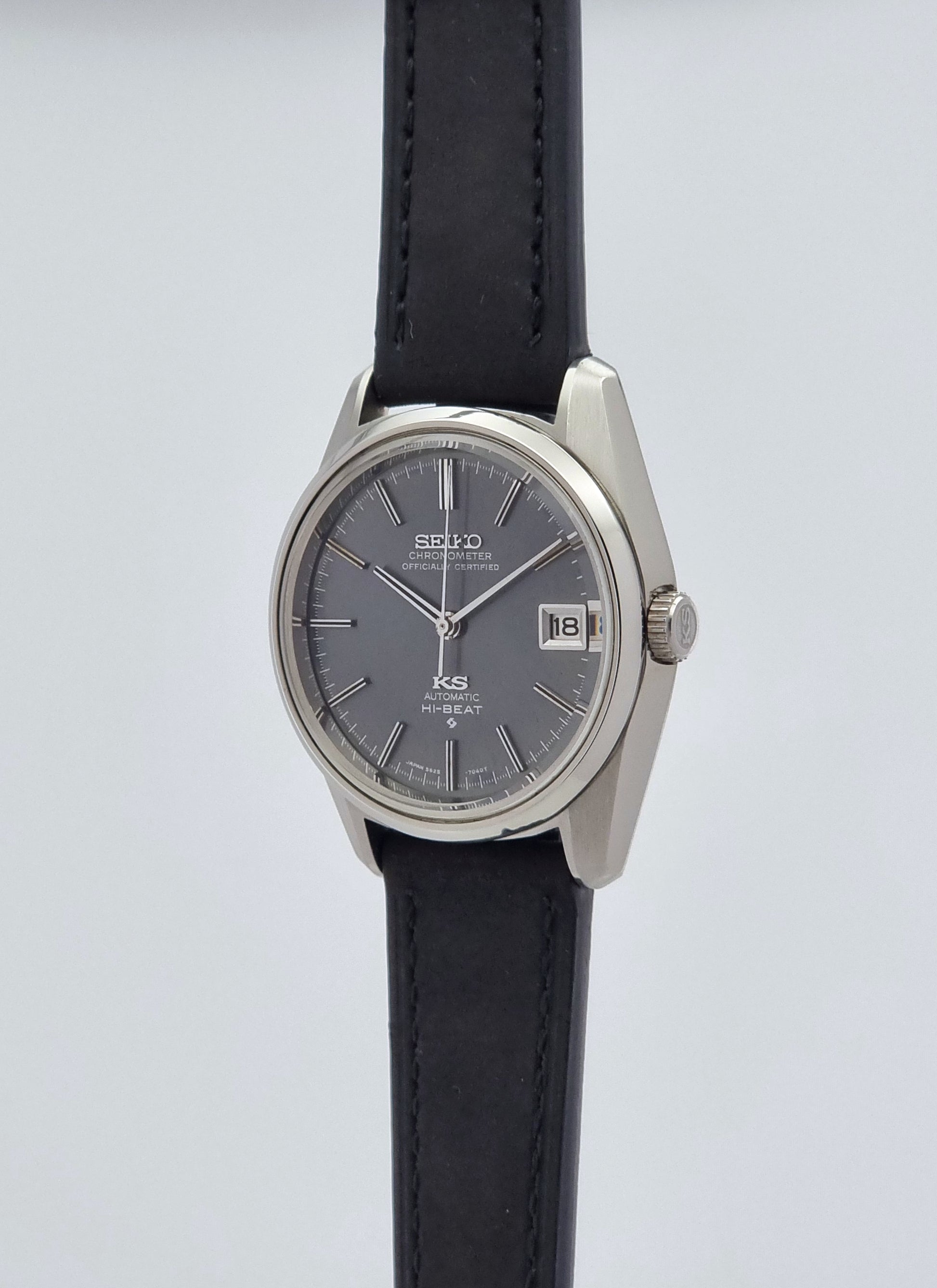 Vintage King Seiko 5625-7040 watch watch with black leather strap on a light gray background crown profile view