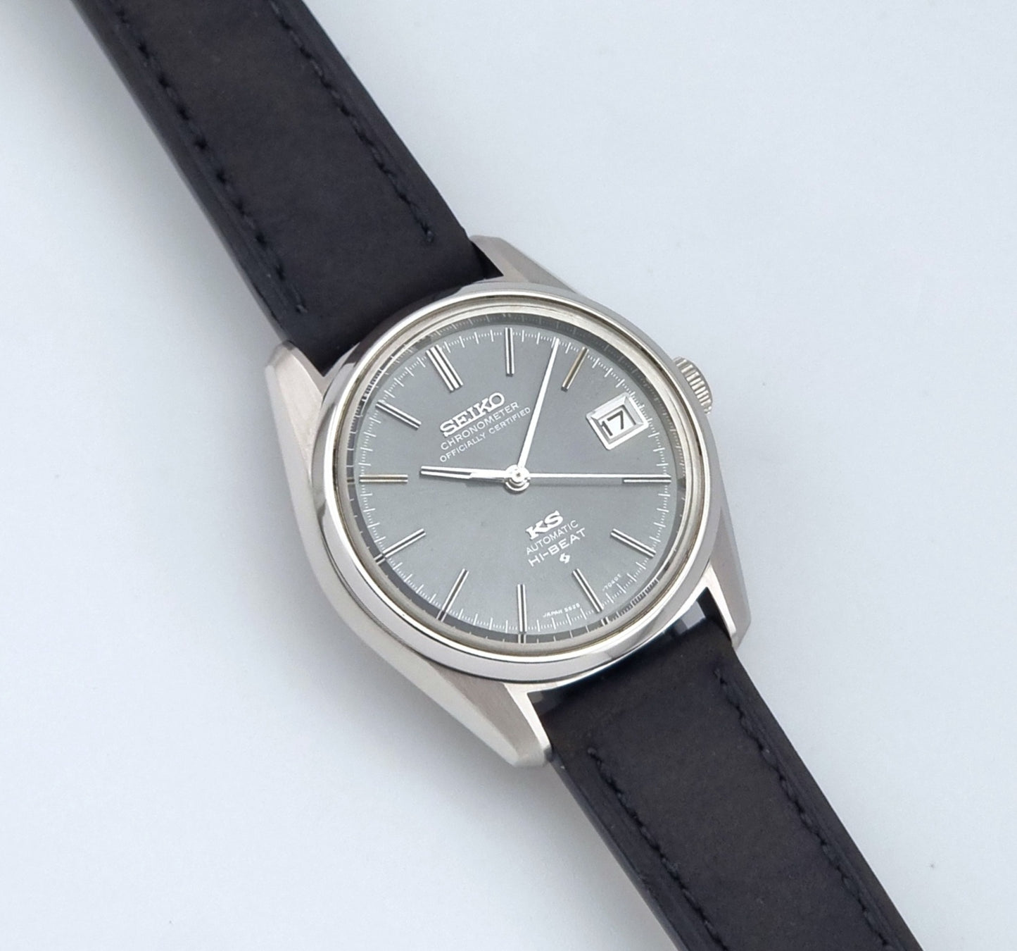 Vintage King Seiko 5625-7040 watch watch with black leather strap on a light gray background close up dial view
