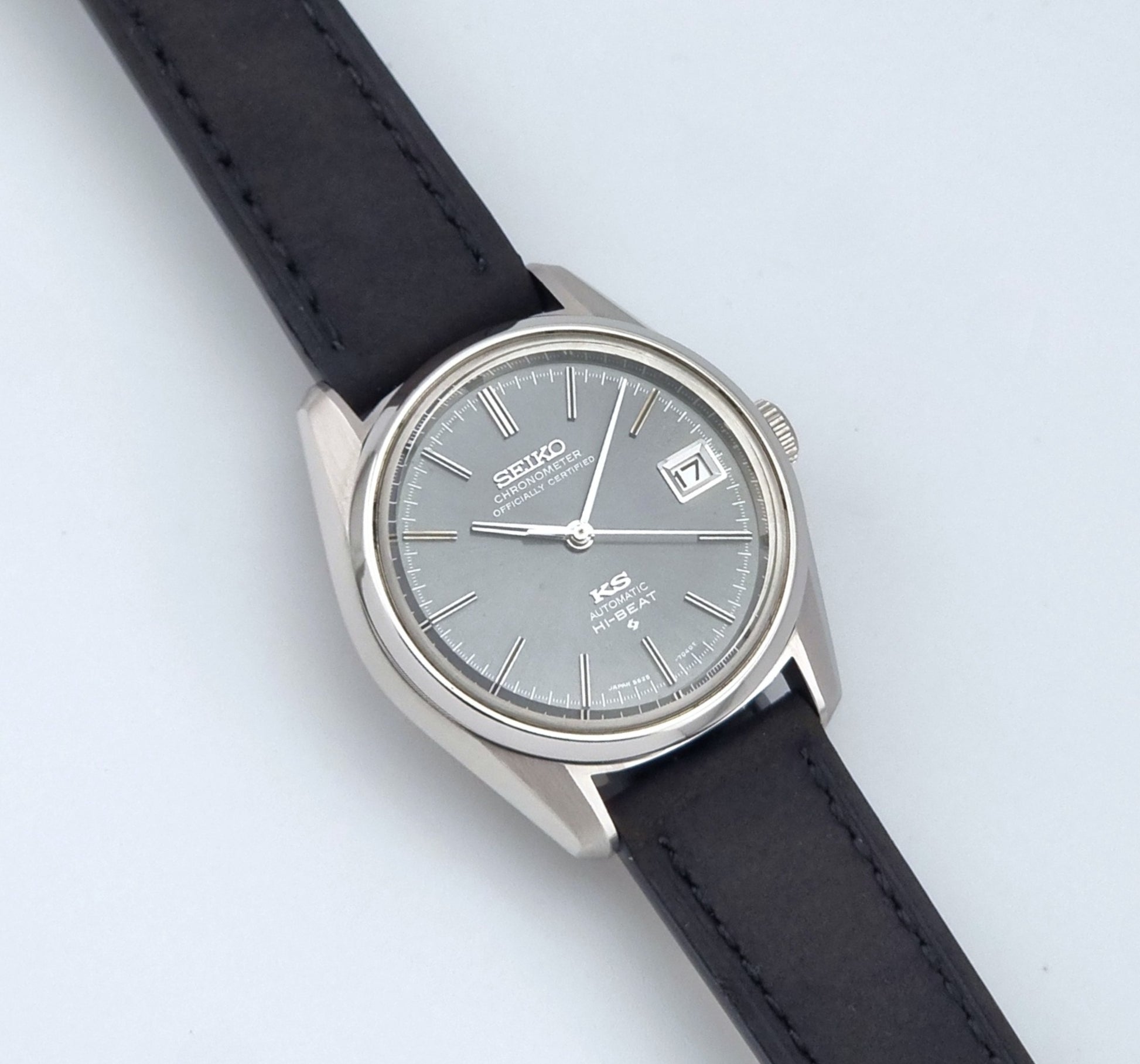 Vintage King Seiko 5625-7040 watch watch with black leather strap on a light gray background close up dial view