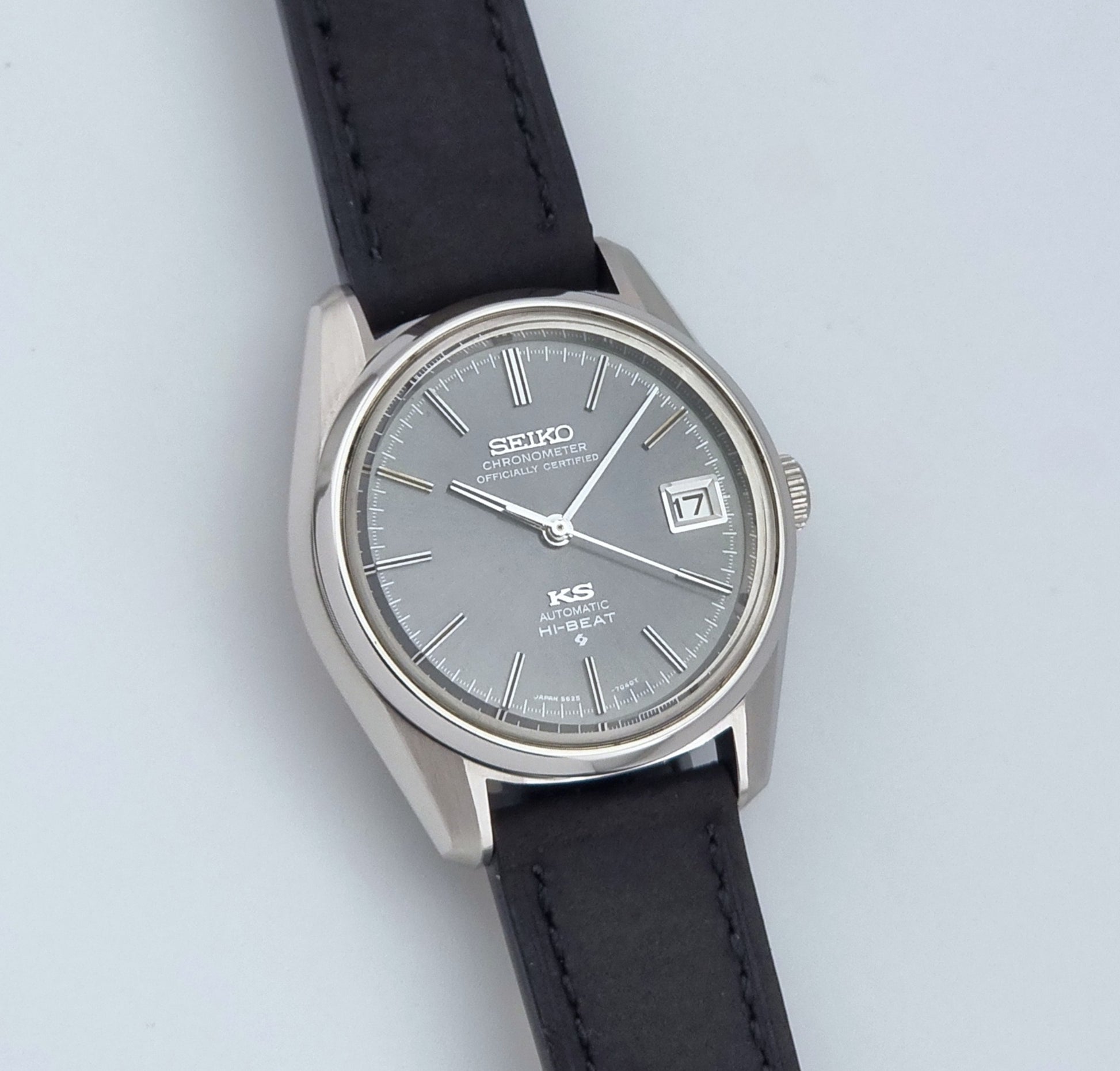 Vintage King Seiko 5625-7040 watch watch with black leather strap on a light gray background front view