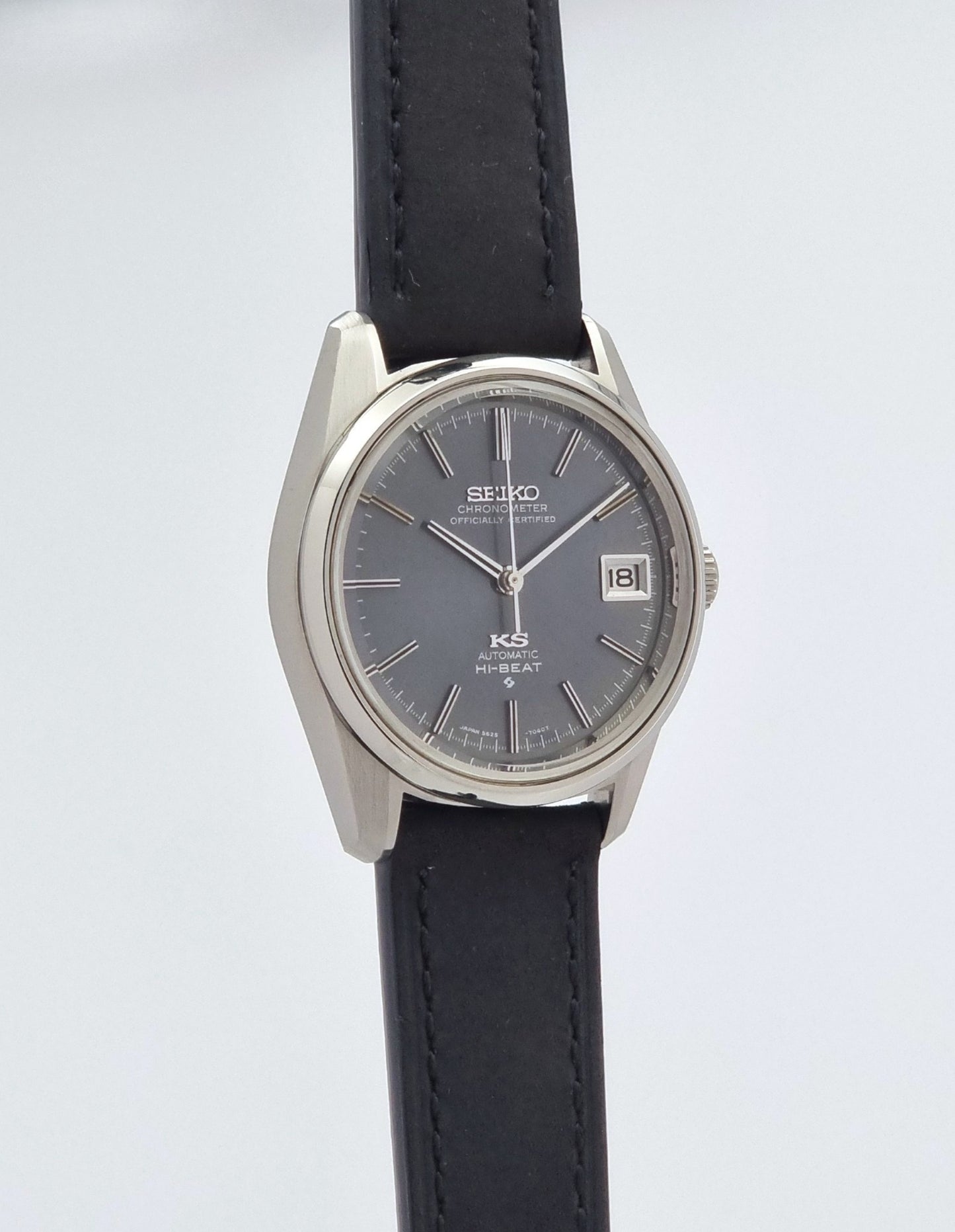 Vintage King Seiko 5625-7040 watch watch with black leather strap on a light gray background side profile view