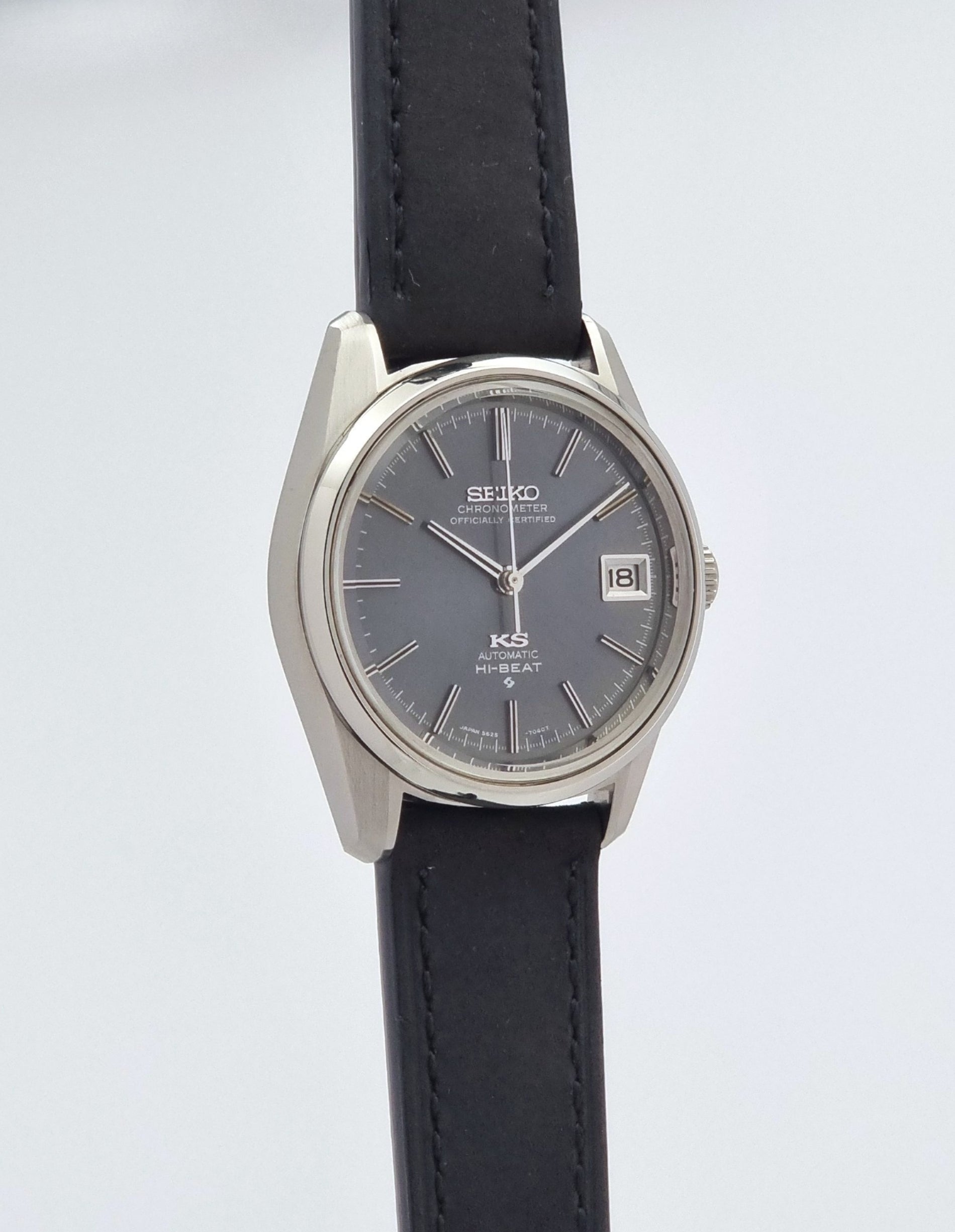 Vintage King Seiko 5625-7040 watch watch with black leather strap on a light gray background side profile view