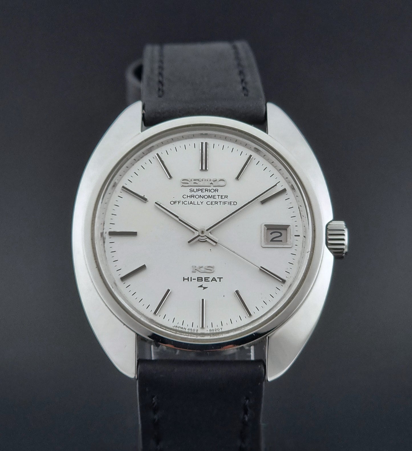 Vintage King Seiko Watch 4502-8010 with black leather strap on a dark surface dial view