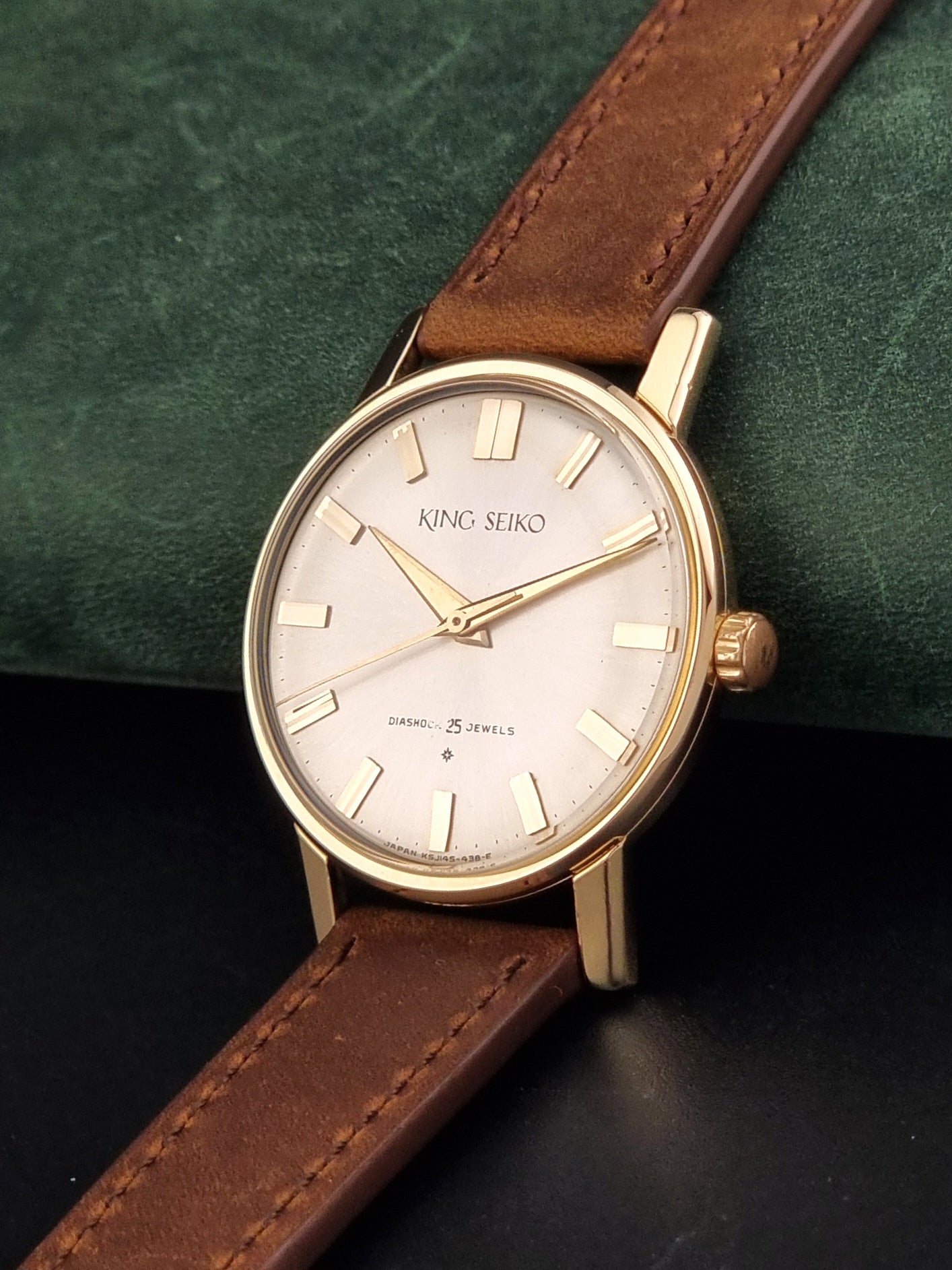 Vintage King Seiko J14102E Watch with brown leather strap on a dark gray background crown view