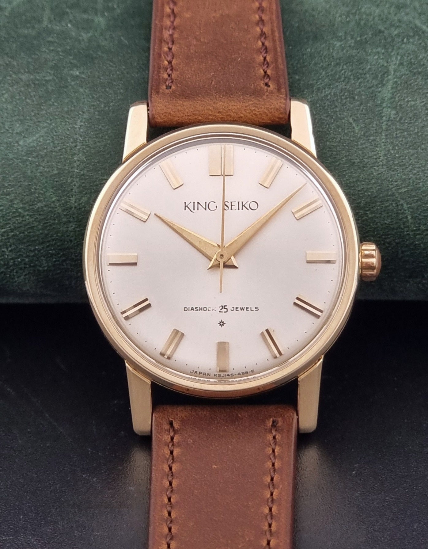 Vintage King Seiko J14102E Watch with brown leather strap on a dark gray background dial view