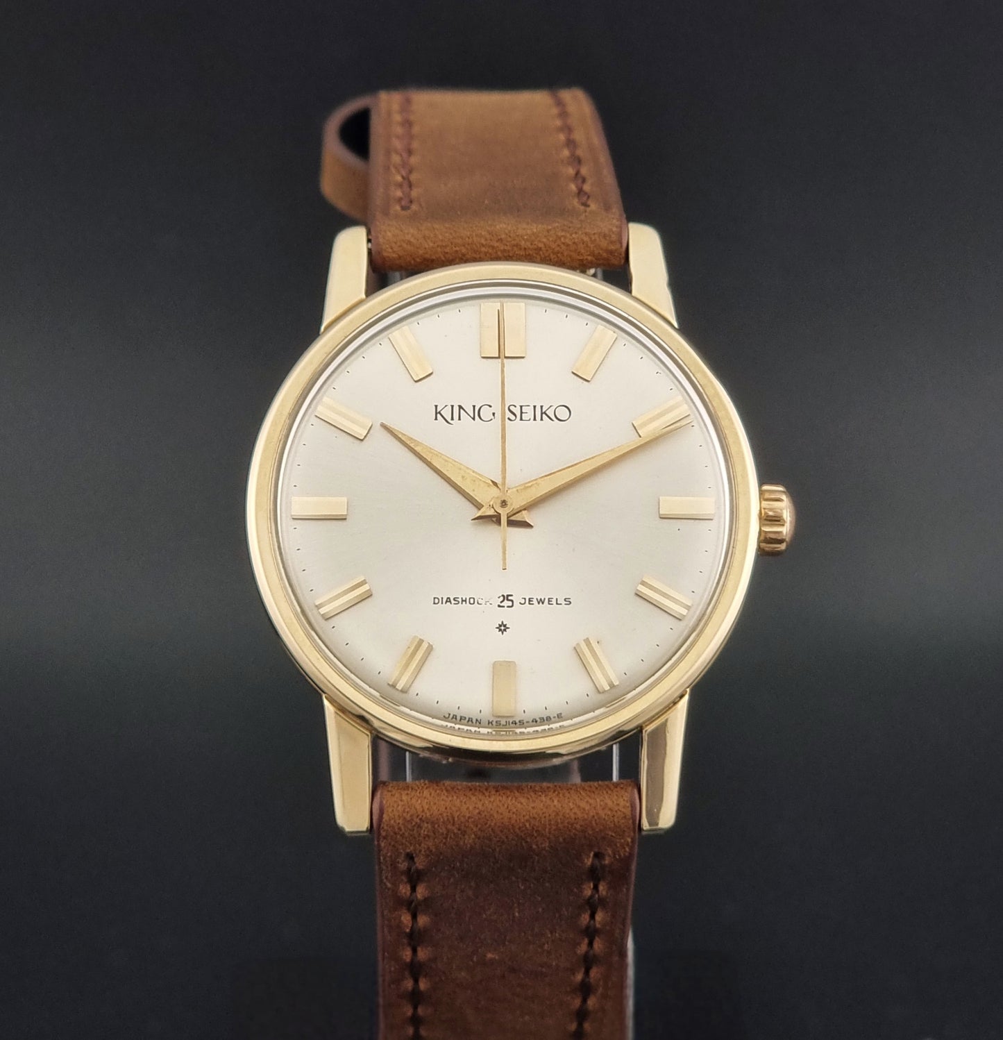 Vintage King Seiko J14102E Watch with brown leather strap on a dark gray background close dial view