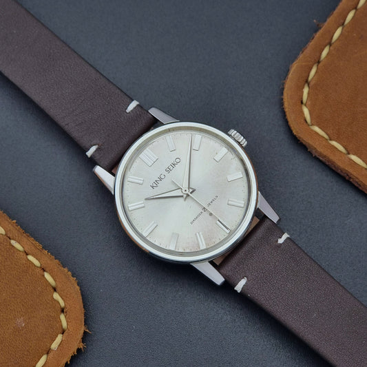 Vintage King Seiko J14102E Wristwatch with brown leather strap on a dark gray background