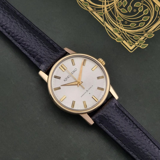 King Seiko Watch J14102 vintage with a black leather strap on a dark surface dial
