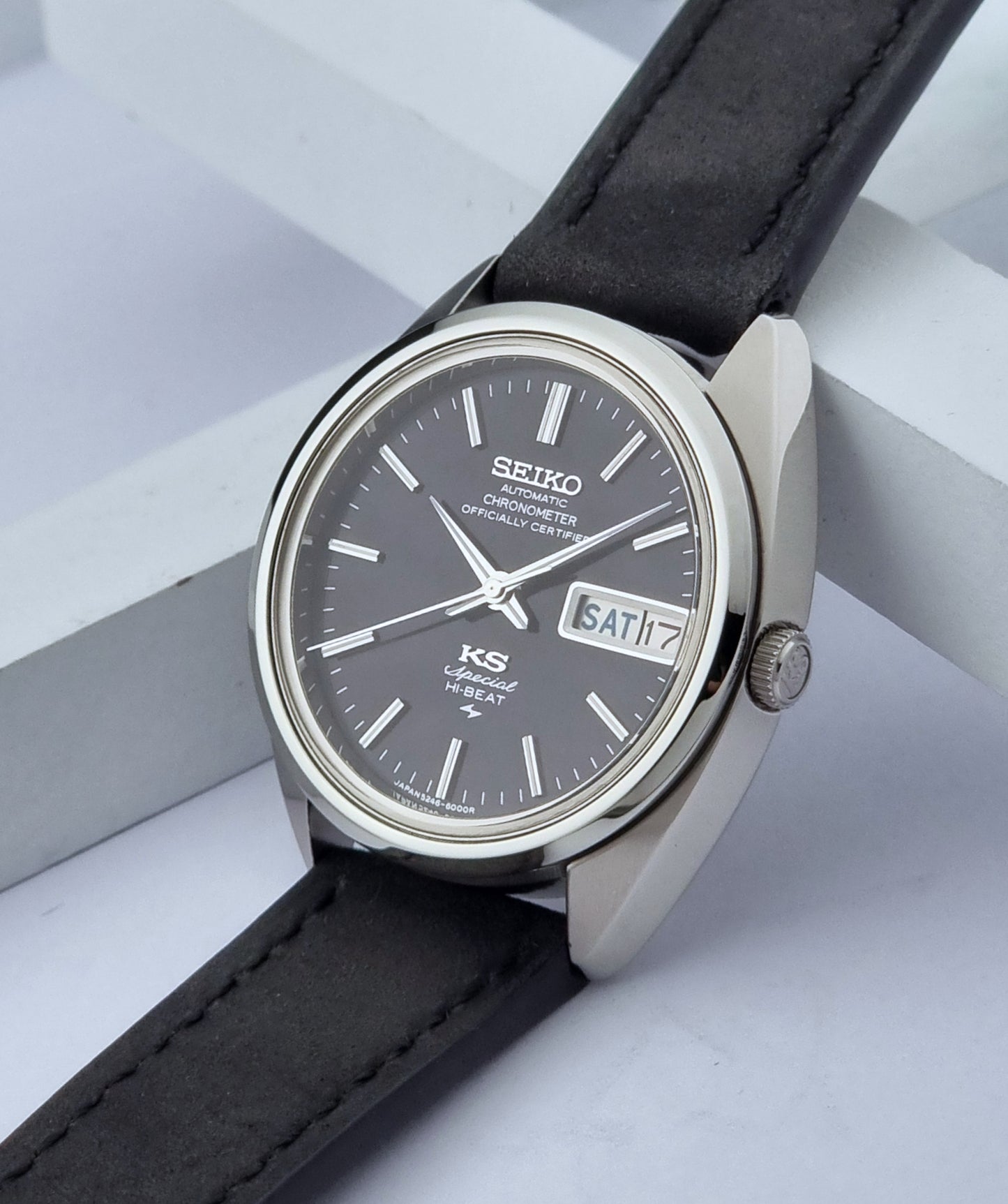 Vintage King Seiko Watch Special 5246-6000 with black leather strap on a light gray background crown view