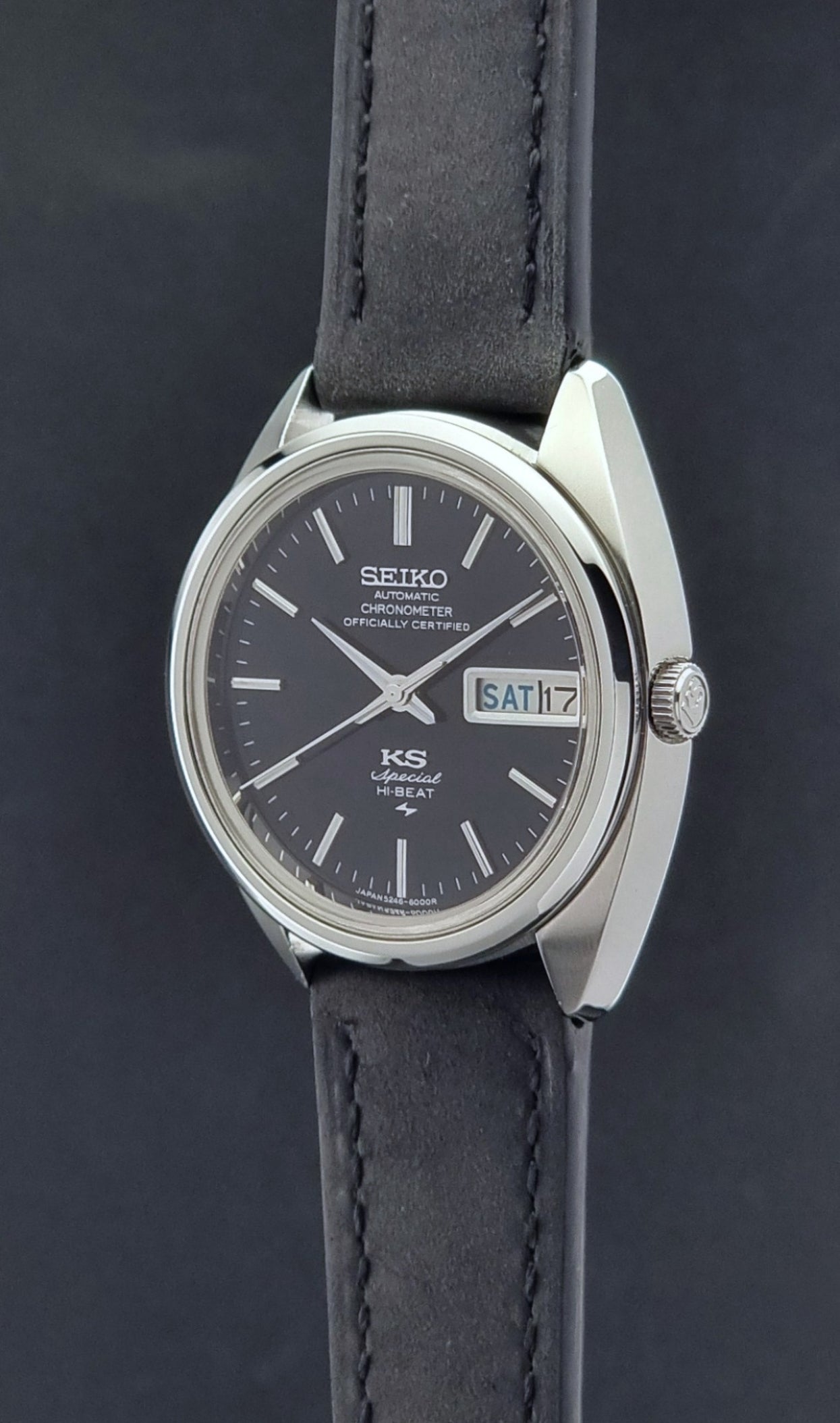 Vintage King Seiko Watch Special 5246-6000 with black leather strap on a light gray background crown profile view