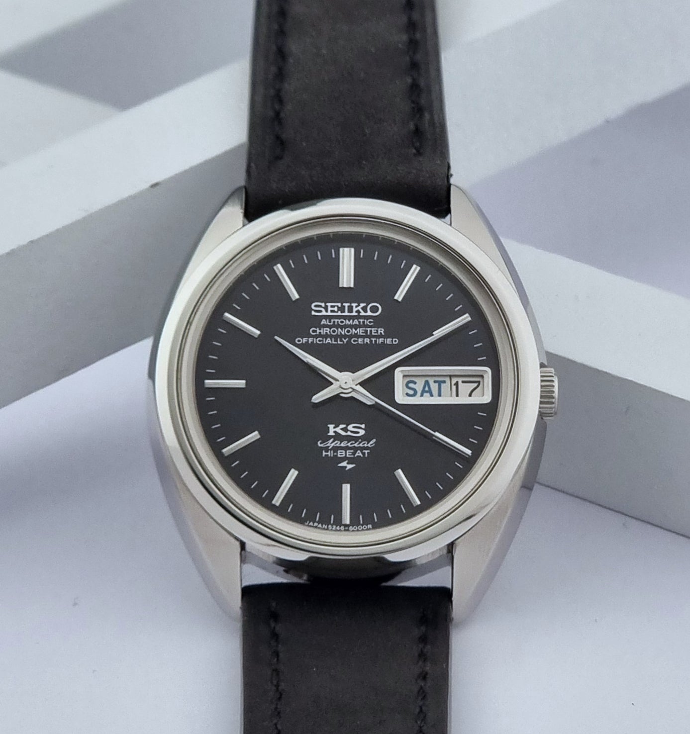 Vintage King Seiko Watch Special 5246-6000 with black leather strap on a light gray background front view