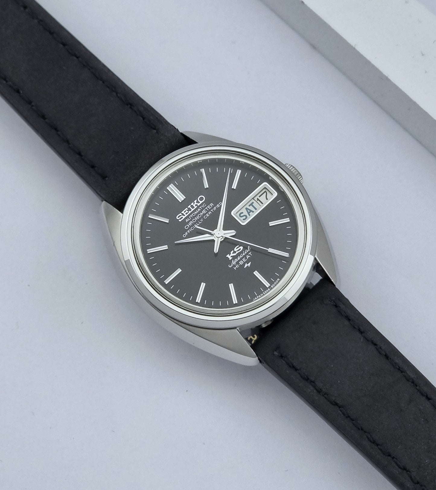 Vintage King Seiko Watch Special 5246-6000 with black leather strap on a light gray background dial
