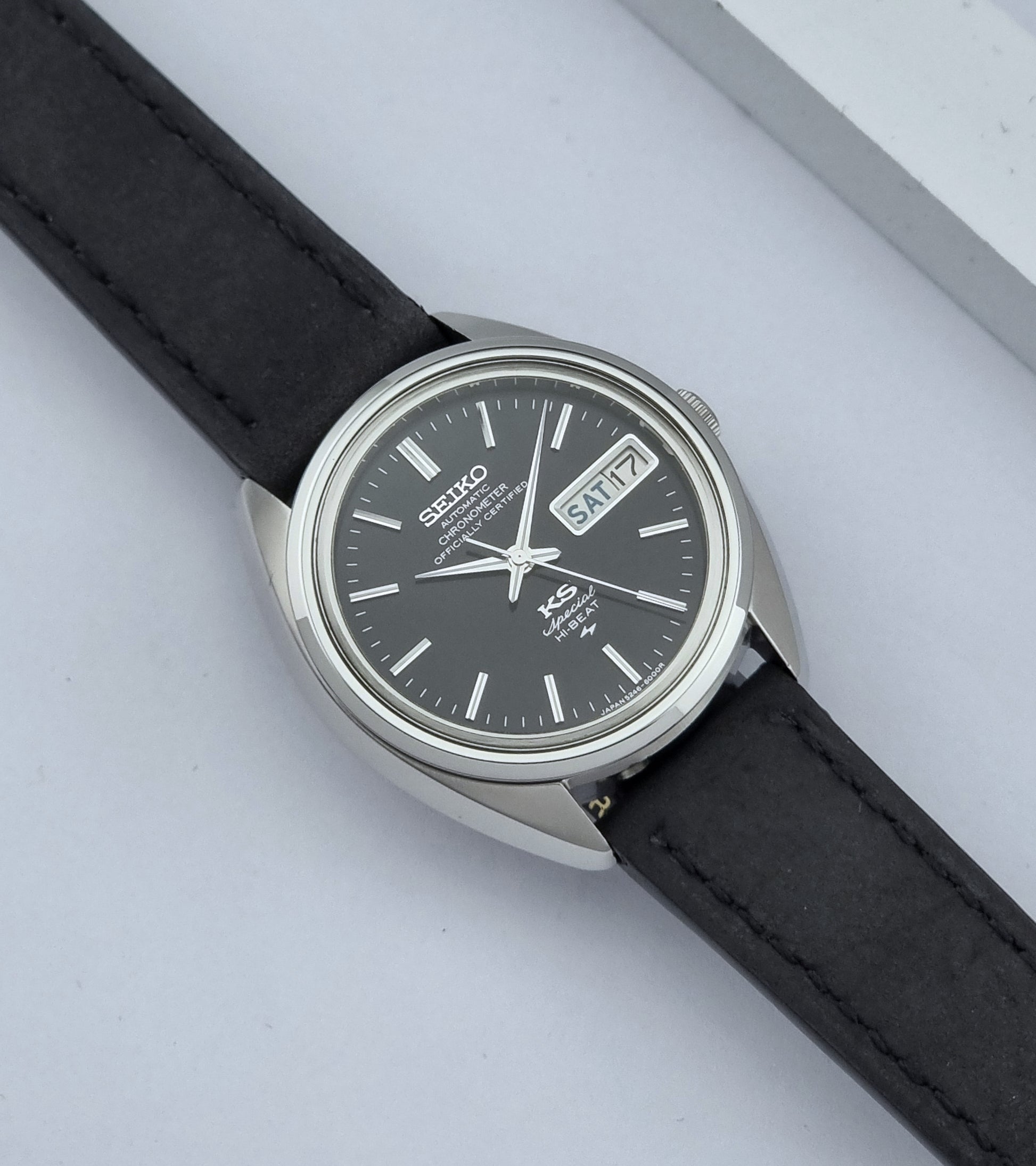 Vintage King Seiko Watch Special 5246-6000 with black leather strap on a light gray background dial