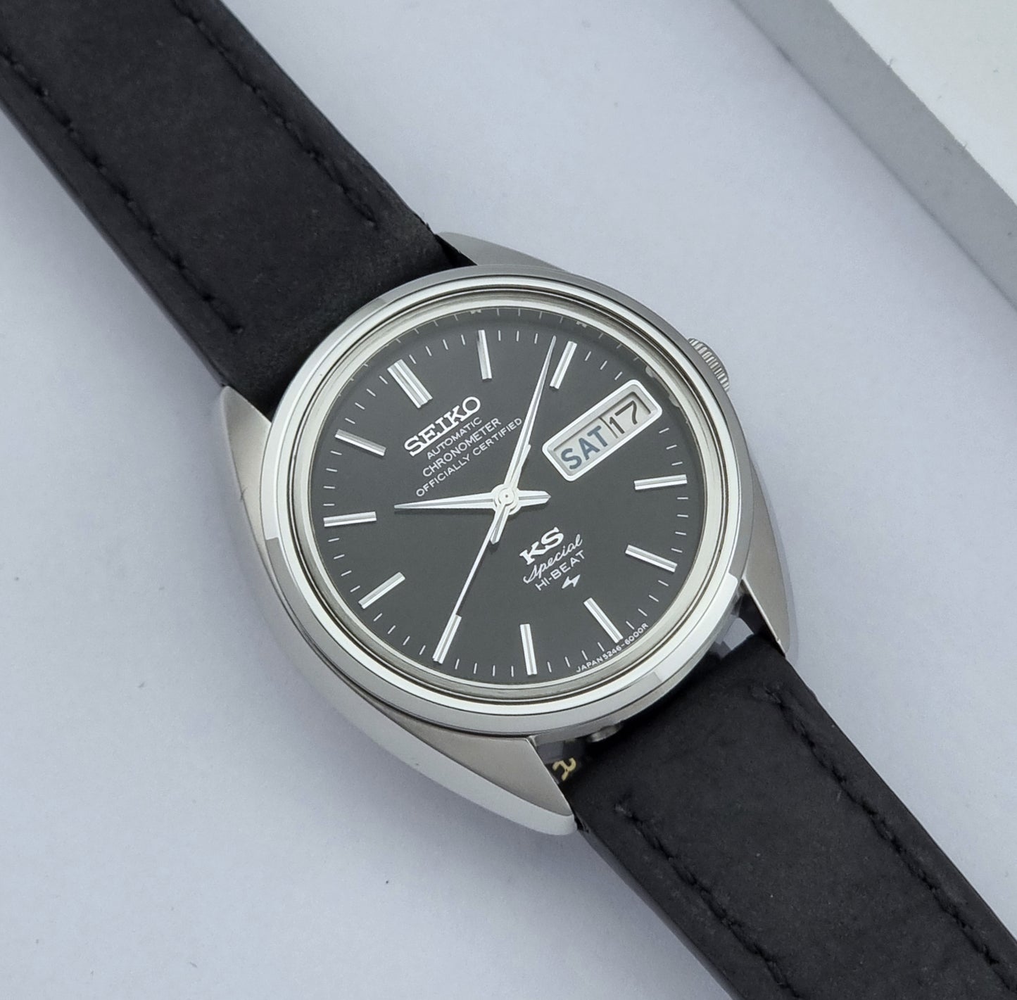 Vintage King Seiko Watch Special 5246-6000 with black leather strap on a light gray background close up dial view