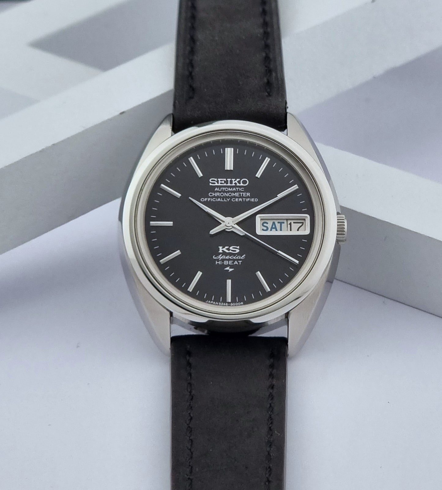 Vintage King Seiko Watch Special 5246-6000 with black leather strap on a light gray background dial view