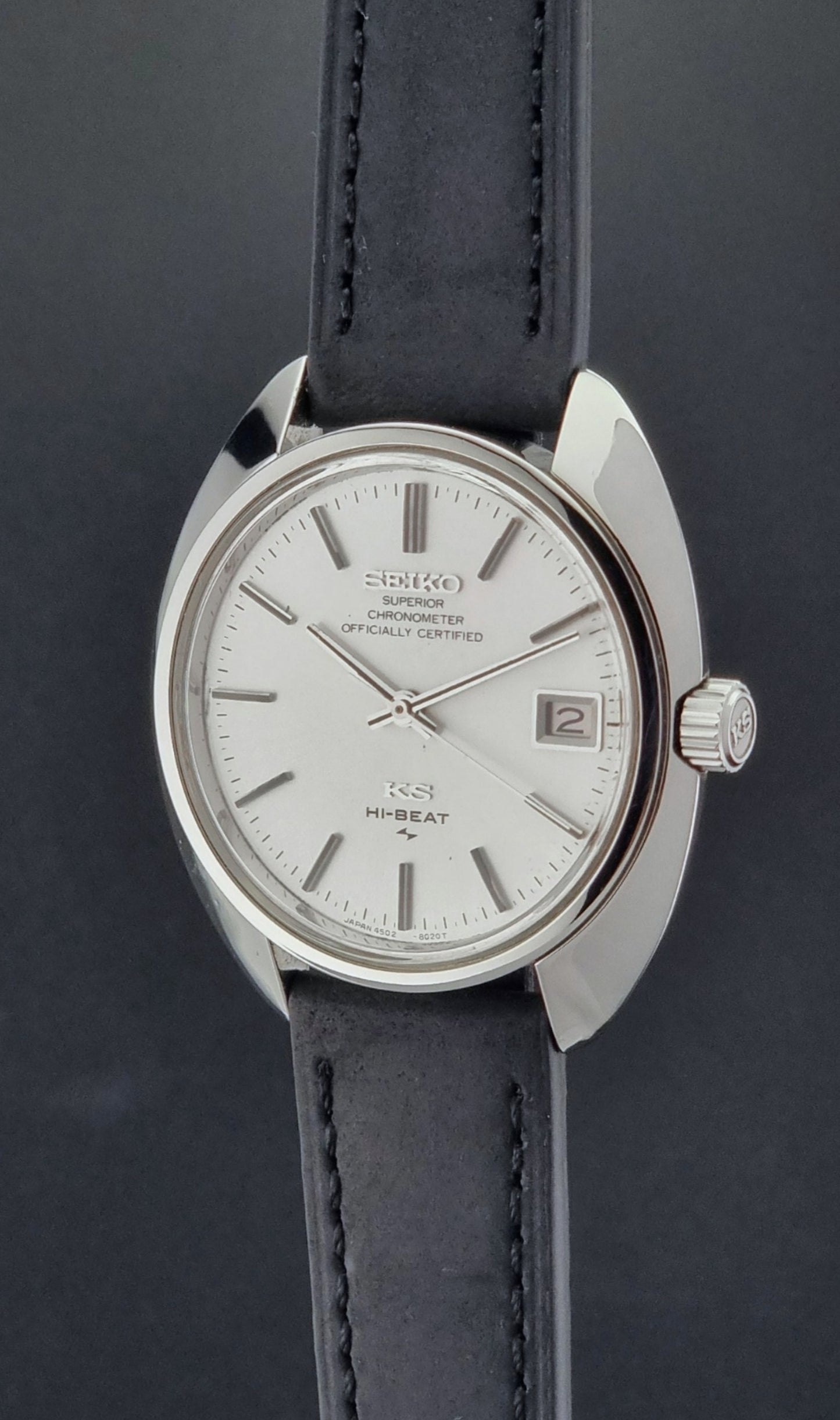 Vintage King Seiko Watch 4502-8010 with black leather strap on a dark surface crown profile view