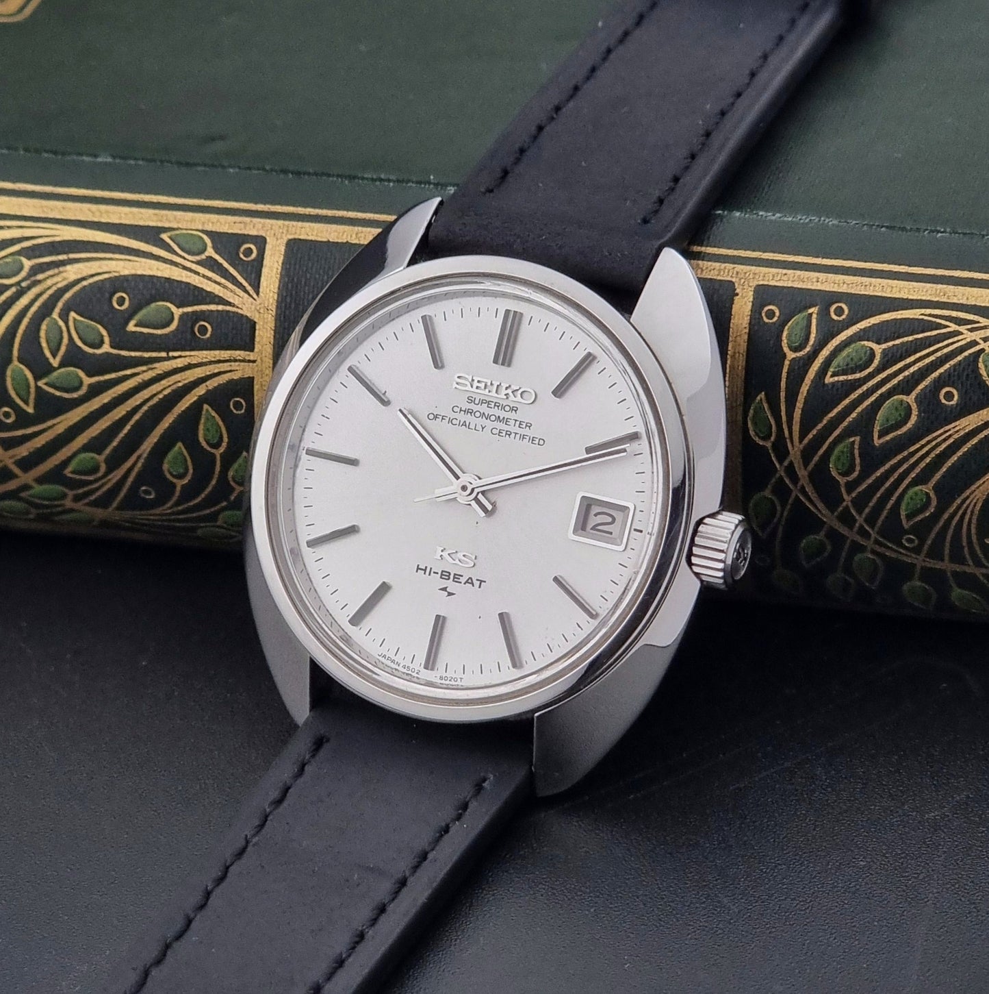 Vintage King Seiko Watch 4502-8010 with black leather strap on a dark surface crown view