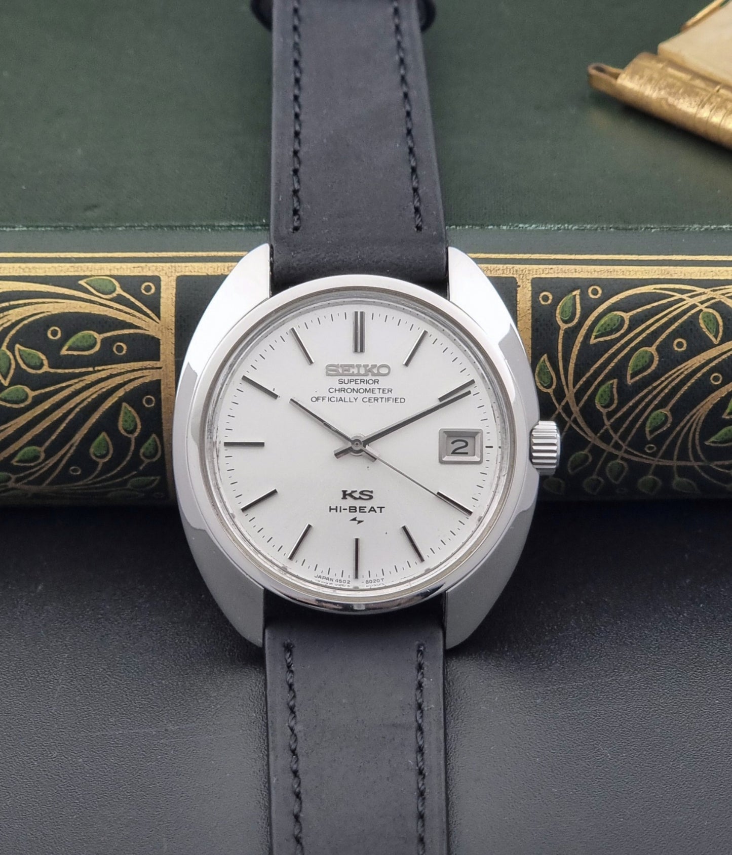 Vintage King Seiko Watch 4502-8010 with black leather strap on a dark surface front view