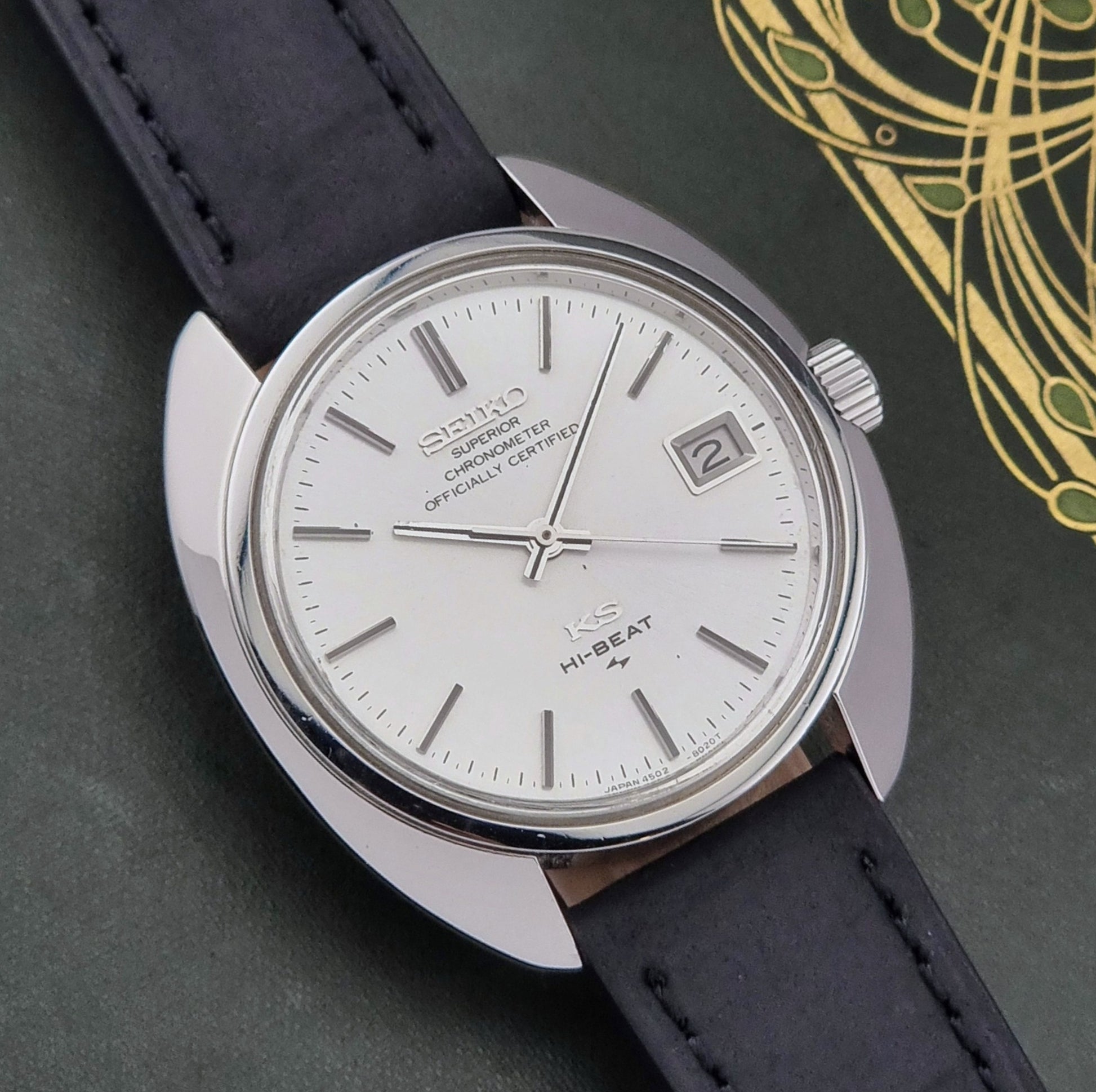 Vintage King Seiko Watch 4502-8010 with black leather strap on a dark surface close dial view