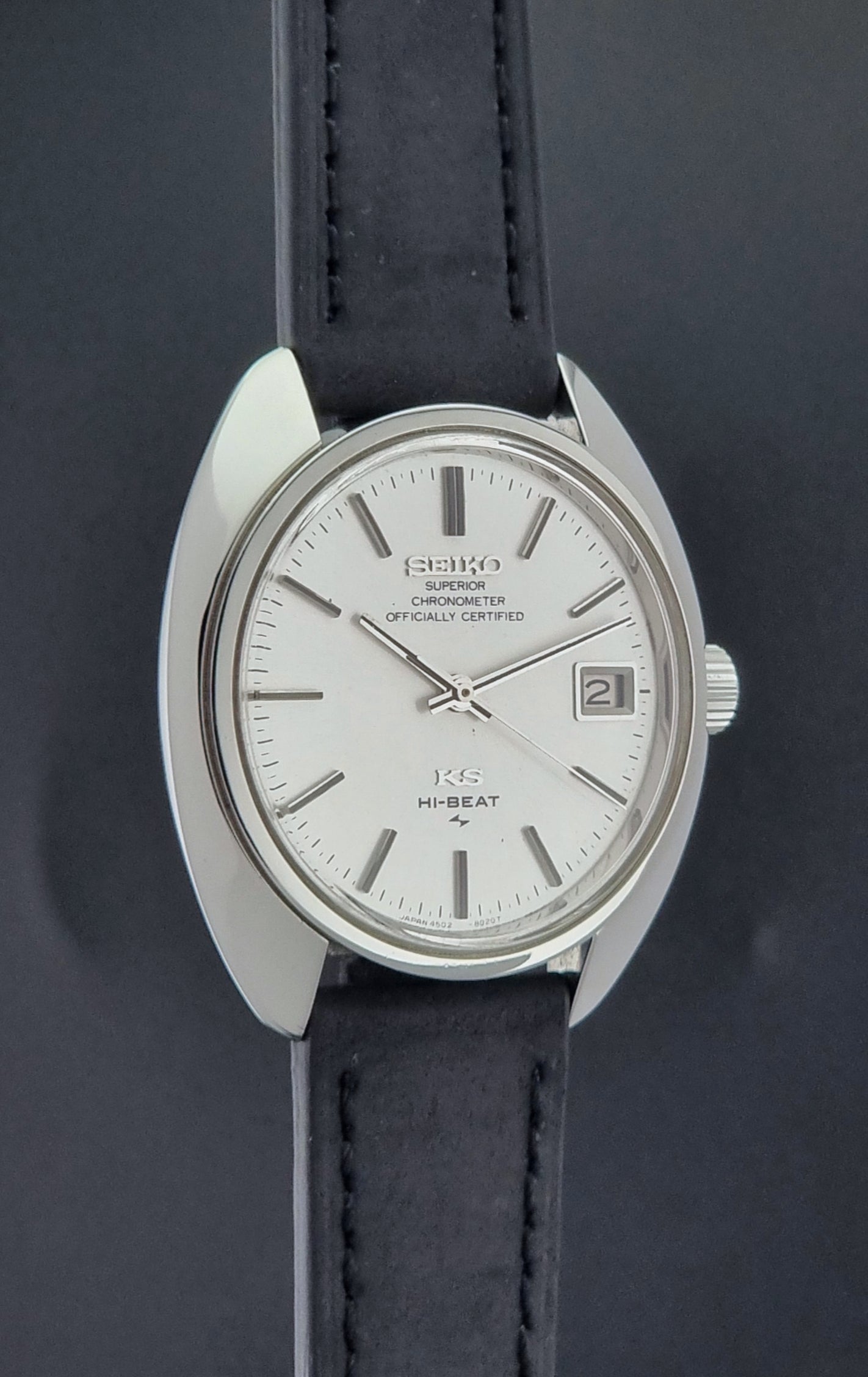 Vintage King Seiko Watch 4502-8010 with black leather strap on a dark surface side profile view