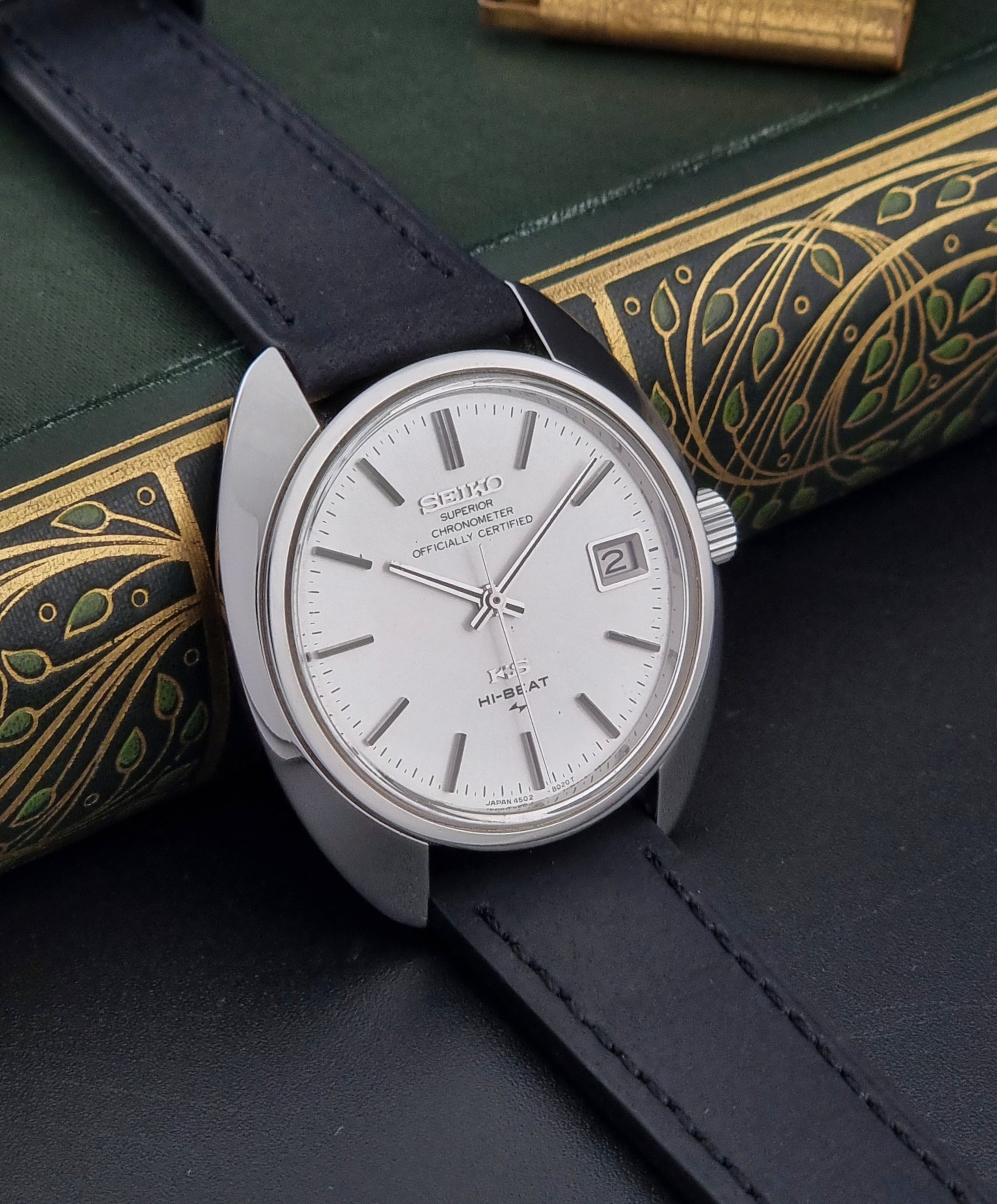 Vintage King Seiko Watch 4502-8010 with black leather strap on a dark surface side view