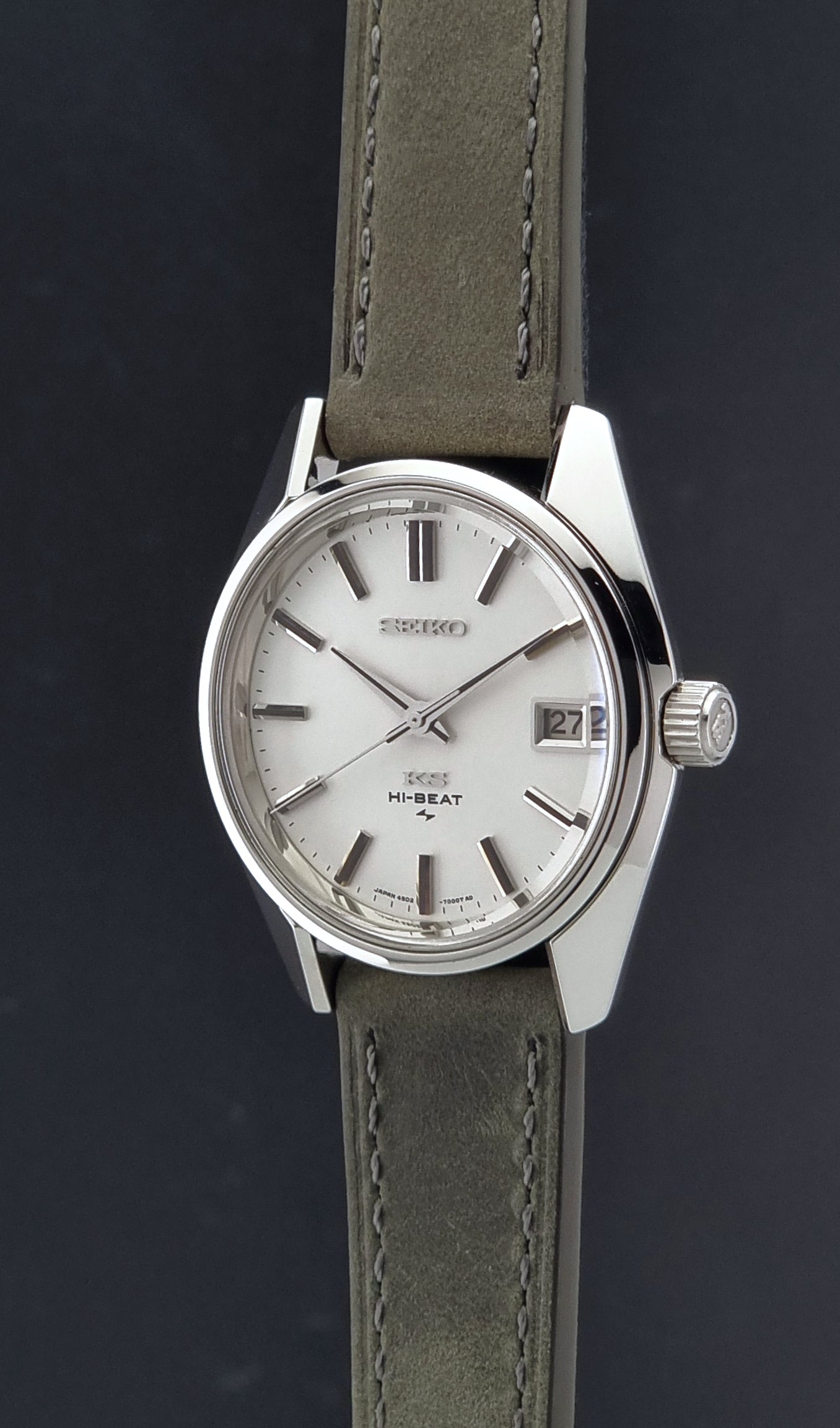 Vintage King Seiko 4502-7001 watch with a white dial on brown background crown profile view