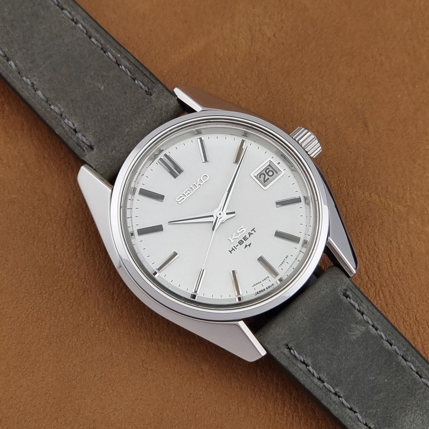 Vintage King Seiko 4502-7001 watch with a white dial on brown background close up dial view